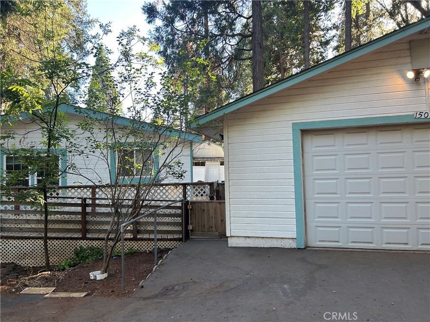 large manufactured home on a level, fenced lot. paved street with water and power. oversized garage and several shop buildings. extra large additional room.wooddecking all the way around home. in the forest with pine and oak trees. near lakes and fishing.