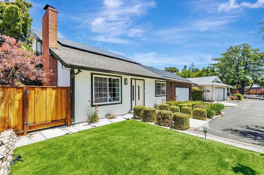 This  move-in ready, modernized two-story home combines timeless modern design with contemporary upgrades throughout. Inside, enjoy a spacious layout with vaulted ceilings in the living room, dining area, and primary bedroom, creating an open, airy atmosphere filled with natural light. The home features a fully remodeled kitchen with plenty of cabinets and a large 4ftx8ft Island, upgraded bathrooms, main bathroom features a walk-in shower and free standing tub, all designed with modern finishes and functionality. Each bedroom includes full-size built-in wardrobes, providing ample storage and organization. Smart home features include app-controlled appliances—refrigerator, oven, microwave, washer/dryer combo—as well as smart toilets and a comprehensive security system. Owned Solar for added savings Outdoors, the front and backyards feature water-saving artificial turf, and a recently installed modern fence for added privacy and curb appeal. A solar-heated pool with premium decking offers a private retreat for relaxation and entertaining. A 2-car garage W/EV charger, additional driveway parking complete the package. Located near downtown Clayton with great restaurant under the foothills of Mt.Diablo, the home is close to scenic trails, parks, quality schools, and everyday amenities