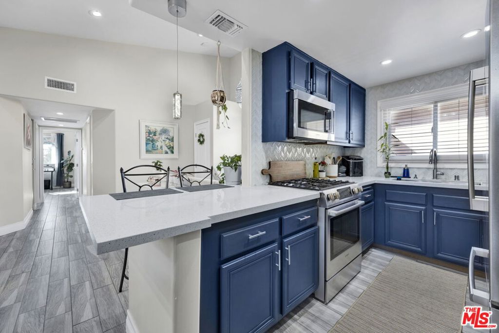 The seller is offering up to 5% of the final price to the buyer for the closing costs and/or to buy down the rate. Welcome to this beautifully updated townhome, nestled in a serene, gated community with 24-hour security. This gem presents two spacious bedrooms and two full bathrooms, offering comfort and style with modern finishes throughout, including a newly installed HVAC for year-round comfort. This corner unit boasts abundant natural light, with large windows that brighten every room, creating a warm and inviting atmosphere. One of the standout features of this unit is the attached garage, a rare find in this community. Located in the heart of Newhall, you'll be just moments away from grocery stores, dining, and other amenities, offering convenience at your doorstep. Perfect for those seeking a peaceful yet connected lifestyle.