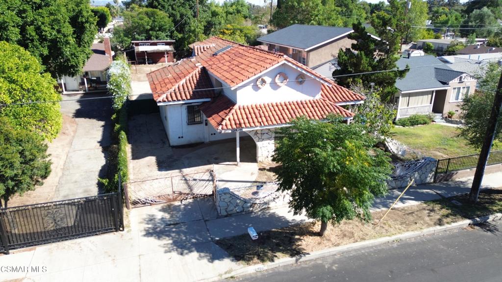 Incredible Mission Hills location and opportunity to buy a semi-completed fixer upper on a massive level lot. Check the street. Many homes have converted to apartments or added multi-units in the back. Perhaps there is room for an ADU? Check with building and safety. The existing home has 3 Bedrooms, 4 Bathrooms with 1,583 permitted square feet. The lot is 9,452 sq. feet. The prior owner began some renovations but never completed them. A gated driveway leads to massive flat backyard with two sheds (not in great condition). The prior occupant used this for his construction business parking. It can accommodate numerous vehicles. Check the local codes for permissive uses.