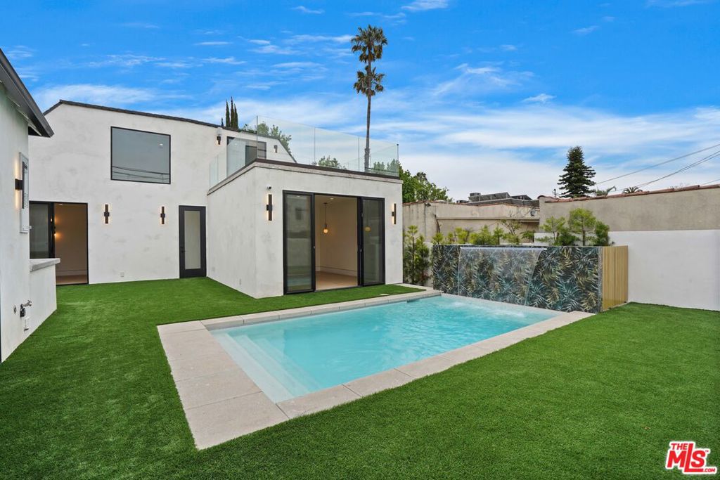 Experience luxury living at its finest in this brand new construction residence boasting 5 bedrooms, a second-story open loft with den or optional 6th bedroom, nestled within the highly sought-after Carthay HPOZ. This English-style home, complete with a pool and ADU, has undergone meticulous remodeling down to the studs while preserving the historical charm of the district. Step through the impressive statement door and onto the covered front patio, setting the tone for grandeur. Inside, the sprawling living room welcomes you with soaring ceilings, a cozy fireplace, and an abundance of natural light, creating an inviting ambiance. The open-concept floor plan seamlessly connects the living spaces, ideal for modern luxury living. The gourmet kitchen features a full island, walk-in pantry, and high-end appliances, perfect for entertaining guests. Retreat to the primary bedroom, which showcases European-style built-in closets, a luxurious full bathroom suite, and access to the backyard and sparkling pool. Completing the bedroom quarters are 3 additional bedrooms on the first floor, providing ample space and comfort for family and guests. The property also boasts a newly permitted ADU with a kitchenette and full bath, offering versatility for hosting overnight guests or enjoying cabana-style outdoor entertainment. With no luxury spared, this exceptional home fulfills the epitome of upscale living in historic Carthay Square. Experience the perfect blend of sophistication, comfort, and timeless elegance in this remarkable residence!