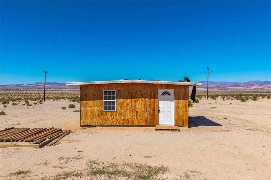 This charming nearly-complete bungalow-style cabin rests on 5 acres in the highly desirable Wonder Valley area, just outside 29 Palms. A true desert gem, where time slows and wide-open views surround you in every direction. Spend your evenings under a blanket of stars, embraced by the quiet beauty of the high desert. The interior is already wired for electricity, with power nearby—simply step in and finish the vision. Buyer to verify boundaries and utilities. The Stars Are Worth The Price of Admission.