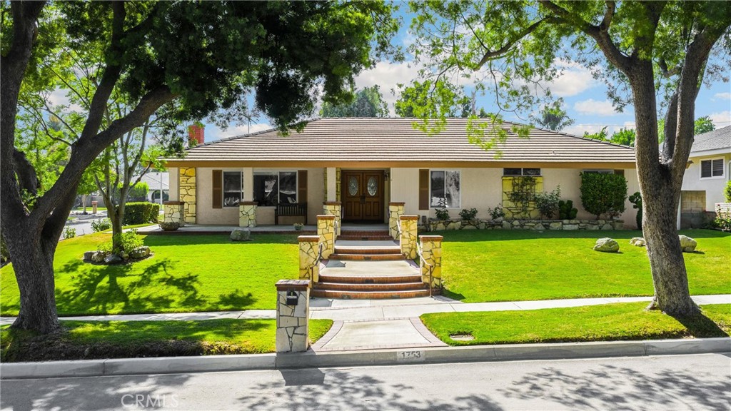 A rare gem in Upland! First time on the market, this beautifully cared-for sprawling single-story home blends timeless charm with generous living spaces. With 4 bedrooms and 3 bathrooms, there’s room for everyone — and then some. Sitting on a quiet corner lot with excellent curb appeal, it’s perfect for a multigenerational household or anyone needing dedicated work-from-home space. Located in a prime neighborhood on a picturesque tree-lined street within the highly rated Pepper Tree School district.
Step inside to a spacious, elegant living room with a charming stone fireplace, a large formal dining room, and a bright, cheerful kitchen with a breakfast bar. A generous laundry room adds everyday convenience. The huge separate family room and expansive bonus room offer endless possibilities — from a home theater to a private retreat for extended family living.
With its beautifully landscaped grounds and spacious backyard, this home is ready for you to make it your own!