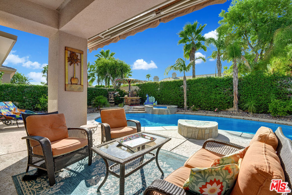 This is the best priced furnished home with POOL and Spa in Rancho Mirage! Available September 1st. Prestigious gated Versailles community , this turnkey 4 bedroom/3 bath home for your most discriminating client. Enter thru private open courtyard. High ceilings throughout, sophisticated wood laminate flooring, dining room opens to living room and den. Open gourmet kitchen leads to family room. Double sided fireplace between family and living room. Master bedroom leads to a private attached cabana space perfect for relaxing by the pool and spa. Each bedroom offers ensuite living. The fourth bedroom is privately situated off garage and could double as a private office/study. The patio space is spacious enough for daytime or nighttime entertaining. At night use the fire pit or the raised spa. A mini putting green to practice your golf skills and tiki bar by the pool. Tennis players can have almost exclusive use and walk to the adjacent court!! It's perfect desert living, incredible landscape and immaculate furnishings! Available September 1st .