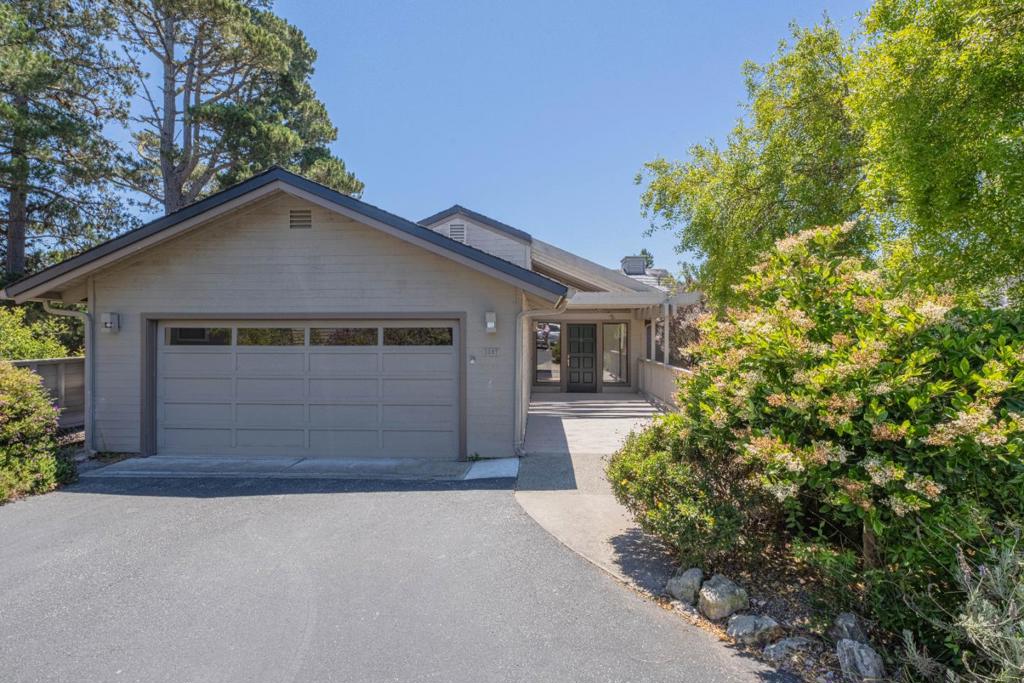 Nestled within the gated High Meadows community, this detached PUD home has been lovingly maintained by the same family since it was built. Offering three bedrooms and two-and-a-half bathrooms, the mostly single-level home features soaring vaulted ceilings in the living room, a gas-log fireplace, and newly refinished wood flooring throughout. Step out onto the rear deck to enjoy sweeping valley and ocean views all the way from Mid-Valley to Point Lobos. The attached two-car garage includes a washer and dryer, along with access to a spacious attic for additional storage. Whether you're looking for a charming move-in-ready home with its original character or a blank canvas for a custom interior remodel, this property offers exceptional potential in a highly desirable High Meadow location.