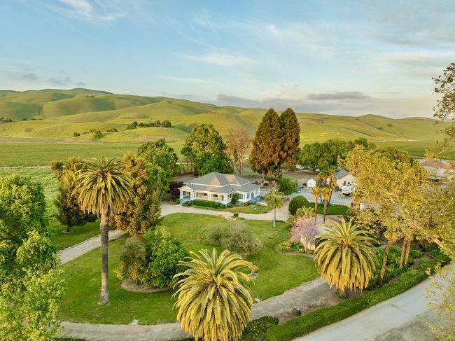 This is a rare opportunity to Own a Piece of California History. Step back in time with this extraordinary colonial estate, a timeless treasure with a legacy as rich as its architecture. Initially built by the distinguished Dunne family, this grand residence was featured in the 1907 Gilroy Advocate as one of the finest homes south of San Jose. Once part of a vast, sprawling ranch, the estate now rests on 10 beautifully preserved acres, offering a rare glimpse into California's past. The stately primary residence spans nearly 5,000 square feet with a partially finished basement. It showcases classic colonial design, intricate moldings, detailed carvings, a graceful wraparound porch, and stunning grounds with character and charm. The estate also includes a charming 3-bedroom, 1-bath cottage ideal for guests or extended family, and a 6-stall barn with a tack room and hay storage, offering exceptional versatility for equestrian or ranching pursuits. More than just a home, this is a living legacy, an opportunity to own a historic estate that has stood the test of time for over a century.