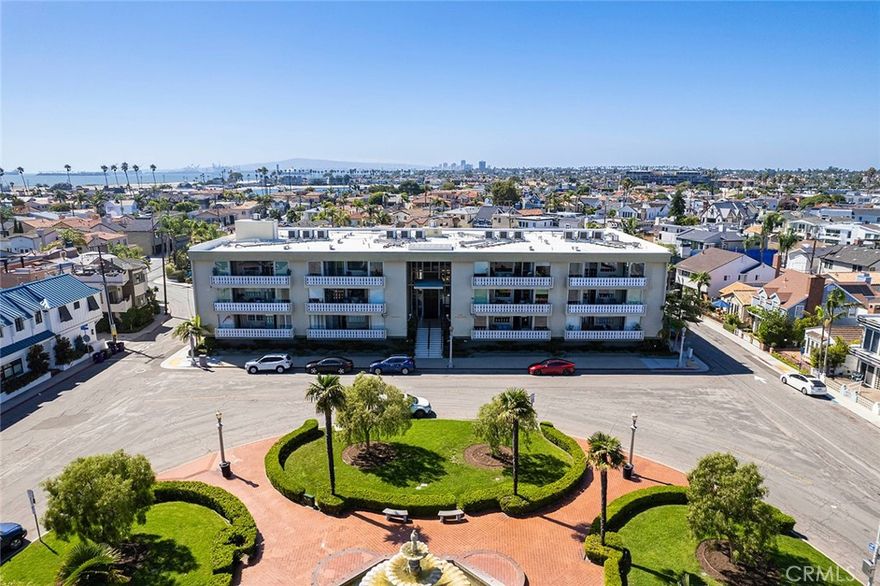 Experience coastal living in this beautifully updated condo on sought-after Naples Island. This 2-bedroom, 2-bathroom condo has 1,121 sq. ft., and offers abundant natural light and refreshing ocean breezes. Upcoming installations of three new floor-to-ceiling sliding glass doors will lead you to a generous balcony, perfect for enjoying the outdoors. The condo features an updated kitchen with modern cabinets and newer appliances including cooktop, oven, microwave, dishwasher, refrigerator and washer/dryer. Enjoy the elegance of designer light fixtures, luxury vinyl plank flooring, and custom shades throughout. The main living areas include a spacious living room, a dining area, and a separate breakfast nook that can also be used as office space. The primary bedroom features a full bathroom with both a shower and a tub, while the guest bedroom is complemented by a 3/4 bathroom with a new vanity. Additional conveniences include central heating and air conditioning.  One designated parking space with extra storage is located in the subterranean garage. Villa Di Napoli Condominiums offers secure entrance, a community pool, elevator access, bike storage. Water and trash services are included. Enjoy easy access to nearby canals for kayaking and paddle boarding, as well as bike paths, and the vibrant shops and restaurants of Naples, Belmont Shores, 2nd & PCH, and Marina Pacifica. Please note, no pets are allowed.