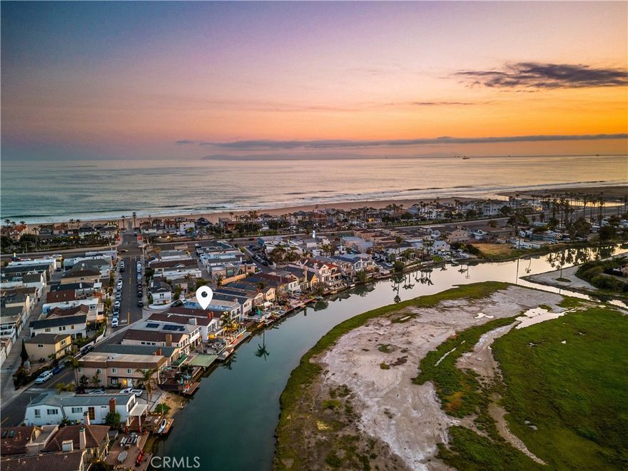 Experience endless water views and refreshing ocean breezes from this elegant four-bedroom, three-bath canal-front residence in Newport Shores—just two blocks from the beach. The spacious kitchen, appointed with quartz countertops, flows seamlessly into the open dining and living areas, both extending to a canal-facing deck ideal for entertaining or unwinding by the water. The primary suite features dual closets, a spa-inspired bathroom, and a private balcony spanning the length of the home, capturing captivating canal views. A desirable main-level bedroom with an en-suite bath complements two additional upstairs bedrooms, each showcasing designer finishes, generous closet space, and beautifully updated baths. A versatile bonus room with a built-in coffee bar opens to a private deck, offering a perfect space for relaxation or a home office. Additional highlights include air conditioning, a two-car garage with built-in storage, and extra exterior parking. Residents of Newport Shores enjoy an exceptional array of community amenities, including a pool, tennis, pickleball, volleyball, and basketball courts, as well as a playground, clubhouse, and BBQ area. Blending refined coastal design with an active beachside lifestyle, this home offers the ultimate Newport Beach living experience—just moments from the sand.