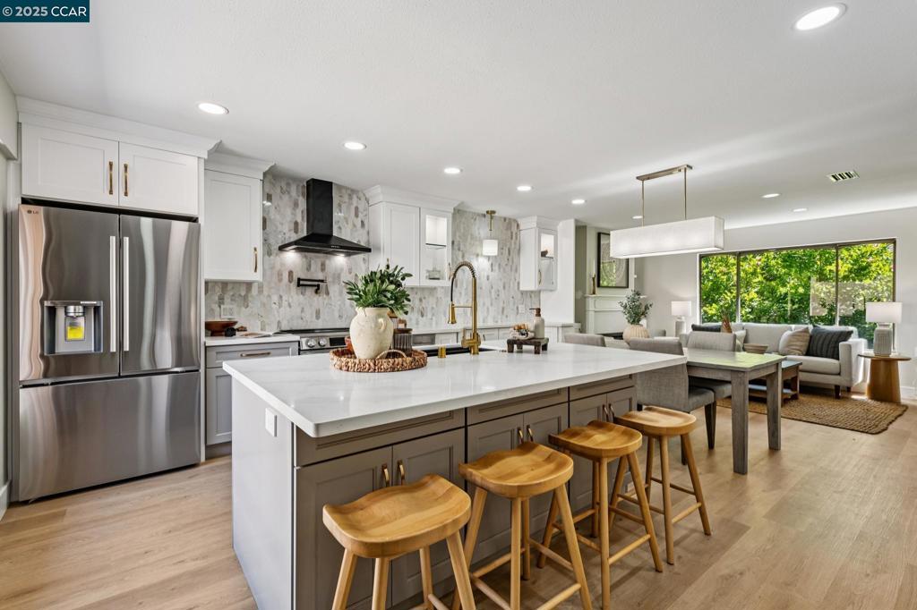 The Grand Aire welcomes you to effortless luxury in this fully renovated, level-in San Franciscan model, expertly crafted by Fred Rooster Renovations. Nestled behind a private front courtyard, this home blends timeless style with comfort and ease. Step inside to a beautifully updated open concept kitchen featuring a massive island, quartz countertops, induction range with pot filler, stainless steel appliances, and a walk-in pantry. Search the kitchen to find the magician's drawer. The main living area features a cozy electric fireplace, designer finishes, and abundant natural light through Milgard dual-pane windows. The primary suite includes patio access, a spacious walk-in closet, and a luxurious en-suite bathroom. An oversized second bathroom with a walk-in shower adds functionality and style, while French doors to the second bedroom make it ideal as a guest room or flexible office/den. Enjoy both a peaceful front courtyard and a private rear patio accessed from the kitchen and bedroom—perfect for morning coffee or afternoon relaxation. Additional comforts include in-unit full-sized laundry, a front door smart lock, and carport parking just a few steps from the front door. Ask your agent about Tailor to Your Taste™ allowance program to help make it uniquely yours.