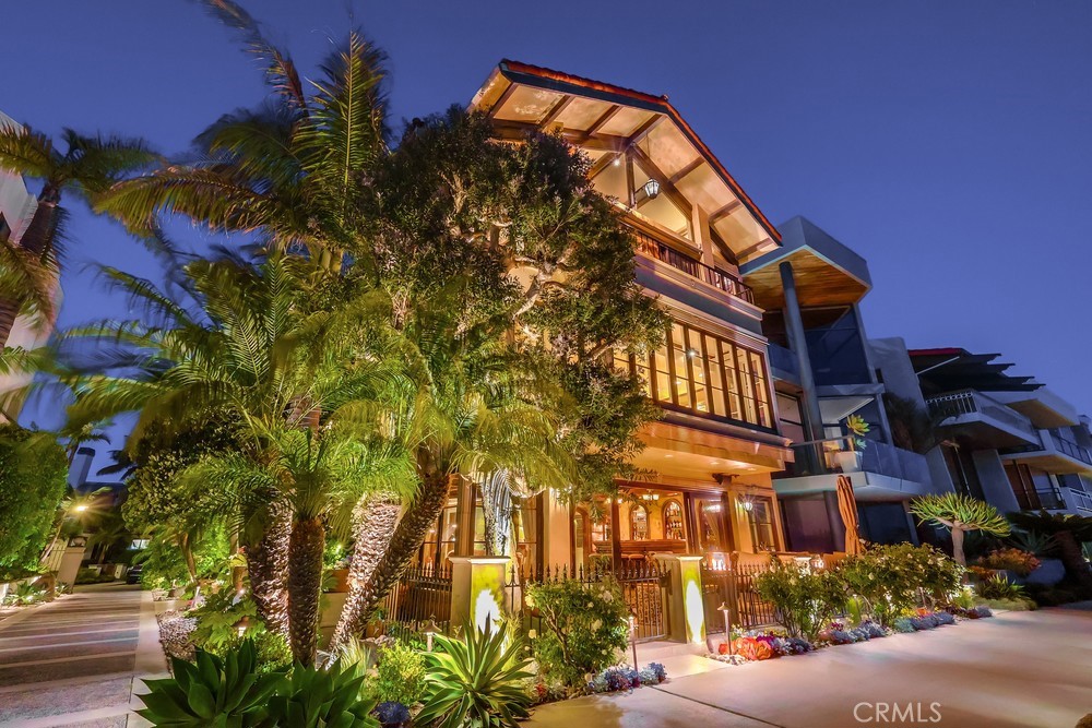 Waterfront Italian Villa with French Elegance on Naples Island’s Prestigious Gold Coast ~
Welcome to a rare opportunity to own a timeless Italian Villa infused with refined French charm, ideally located center stage on Alamitos Bay, this architectural masterpiece offers unparalleled panoramic views —captivating from every level of the home. Lushly landscaped and featuring artful rock detailing and positioned next to a rare wide walkway, this home is bathed in natural light. Stunning custom wrought iron and glass entry door welcome you to the dramatic foyer and the elegant circular staircase that lead you to the beautiful family room adorned with a Mahogany coffered ceiling with gold-leaf detailing, a cozy fireplace, a fully-equipped bar with fridge, ice maker & 3-tap beer tower and a spacious Butler’s pantry & .75 bath, a spacious waterfront patio with Travertine tiling, decorative tile walls, and a retractable canvas awning, for shade and comfort, all overlook the water. An
elegant primary suite, 3 additional bedrooms, are all on the 2nd level. Level 3 features include: a formal grand living room with a fireplace and bar, a powder room, gorgeous formal dining room and Signature kitchen with custom Clive Christian cabinetry, featuring: La Cornue Chateau French range, a large island with custom inset detailing on ceiling, a hammered copper sink, 2 Sub-Zero refrigerator drawers, plus 2 dishwashing drawers, 2 large built-in Sub-Zero refrigerators and 4 freezer drawers, a Meile dishwasher, walk-in pantry with handcrafted cabinetry, Sub-Zero wine fridge with 2 refrigerator drawers, and a built-in banquette seating & table. There are 3 expansive levels + finished basement, with a temperature controlled wine cellar, and an elevator servicing all floors. A meticulous level of detailing, exquisite lighting, Mahogany doors & custom murals throughout, make this a definite must see. A spacious laundry room with custom cabinetry, sink & dishwasher is located on the first level. A 3 car garage with epoxy flooring and plenty of built-in storage and a large, self-contained u-shaped dock – ideal for boating enthusiasts!