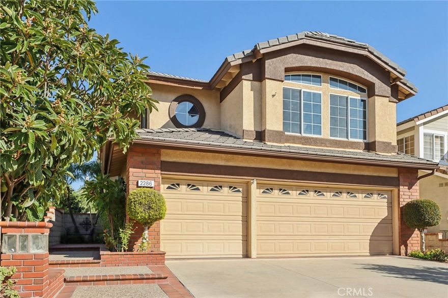 Beautifully updated home featuring an open floor plan with connected living, dining, and kitchen spaces perfect for entertaining. The remodeled kitchen showcases quartz countertops, richly hued cabinetry, stainless steel appliances, a spacious pantry, built-in buffet, and a large island with bar seating for eight. The family room offers a cozy fireplace and views to the backyard retreat. Enjoy outdoor living year-round on the spacious covered patio complete with ceiling fans, a built-in island bar, BBQ, and in-ground hot tub—ideal for dining, lounging, and relaxing. Additional features include wood shutters, a powder room, laundry room, and direct garage access. Upstairs offers four bedrooms and two bathrooms, including a spacious primary suite with vaulted ceilings, bay window, walk-in closet, and en suite bath featuring a soaking tub, separate shower, and dual-sink vanity. Low-maintenance landscaping and a convenient location close to markets, schools, and dining make this home the perfect blend of comfort, style, and convenience.