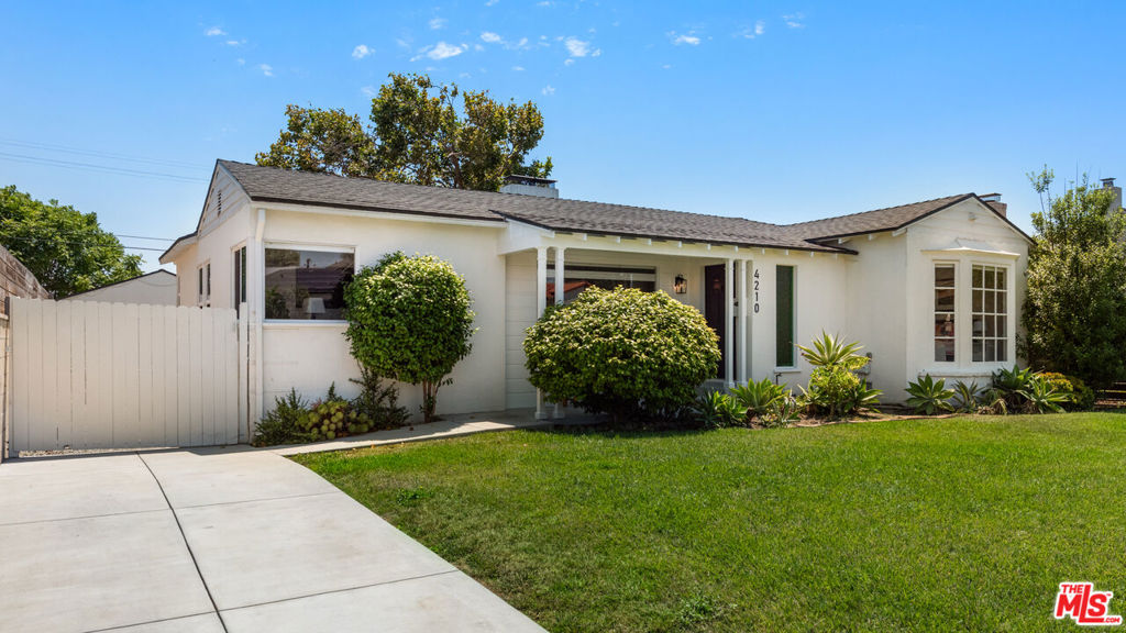 Located in the highly desirable View Heights neighborhood, this rare gem sits on a large, expansive lot. Designed with modern living in mind, the light-filled interior features beautiful wood flooring, a soft, neutral palette, and an open-concept layout centered around a spacious living room with a centerpiece fireplace. The gourmet kitchen is equally impressive, showcasing stainless steel appliances, quartz countertops, a gas range, richly toned cabinetry, stylish open shelving, and a cozy dining nook. The peaceful primary suite boasts ample closet space, while the additional bedrooms provide comfort and room to grow. Modern bathrooms are finished with sleek, contemporary touches that elevate the overall aesthetic. The fully fenced backyard is ideal for entertaining with its large patio and lush green lawn, perfect for weekend barbecues and gatherings. The oversized finished garage with vaulted ceilings offers ideal flexibility for a home office, gym, or creative studio. Enjoy the ocean breeze and a prime location just moments from SoFi Stadium, Downtown LA, the beach, USC, LAX, and the soon-to-be Olympic Village, bringing the best of Los Angeles right to your doorstep.