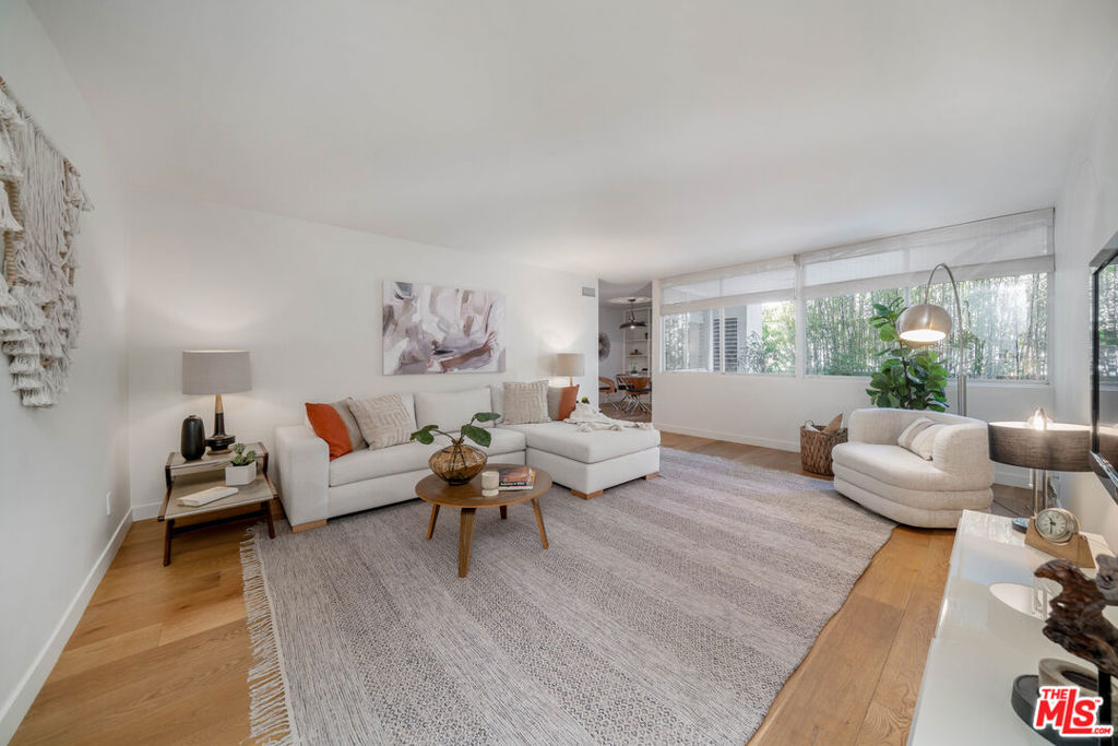 Priced To SELL! Luxurious Living in Beverly Hills! Discover sophisticated city living at its finest in this Landmark Mid Century Modern building designed by the famous Ray Kappe. This completely remodeled 2BD 2BA 1092 sqft condo is located in the back of the building which serves as the perfect private oasis that you have been searching for. Upon entering, you are greeted by a spacious living room with a beautiful botanical view that is perfect for both relaxation and entertainment. Elegant hardwood floors and an inviting ambiance. The custom kitchen has white quartz countertops, white cabinets, stainless steel appliances, a gas rangetop, electric stove, custom dishwasher and ample storage space. Adjacent to the kitchen, a stylish dining area provides an ideal setting for hosting intimate dinners or casual gatherings. Retreat to the primary suite with new double pane windows, new custom wall closet, recessed lighting, brand new carpet, a pristine new en-suite bathroom with a marble double vanity, hex floor tiles and a classic subway tile shower for ultimate luxury. Insulated ceiling for noise reduction. The guest bedroom or office has been transformed into the closet of your dreams which is also removable with new carpet, a floor to ceiling sliding glass door which opens directly to the enclosed patio that offers a serene outdoor space for al fresco dining or morning coffee. The guest bedroom is separated by a charming guest bathroom with a new marble vanity and new tile floor & shower. Newer Hvac / Brand New Washer/Dryer in Laundry closet/ 2nd parking space for $500 per year Conveniently located just moments from world-class shopping, dining and entertainment, Beverly Center, Rodeo Blvd, Robertson Blvd, 3rd Street, Trader Joes, The Grove, LACMA and Cedar Sinai Hospital, the Purple Metro Line coming in 2025, and the Beverly Hills School District this residence is surrounded by the vibrant cityscape and offers a seamless blend of modern elegance and timeless charm. Don't miss your opportunity to experience luxury and sophistication in one of LA's most coveted neighborhoods.