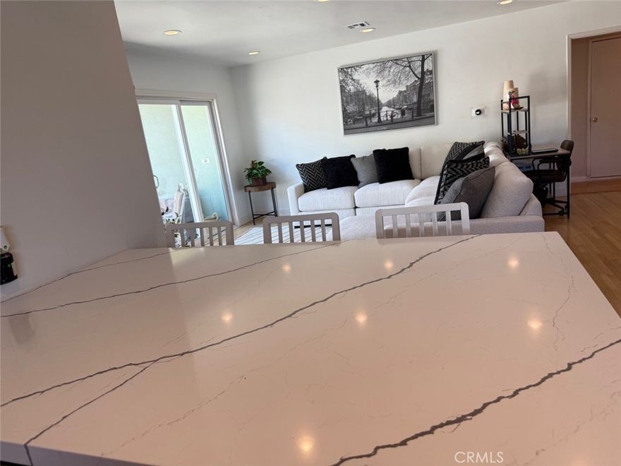 This stunning and private Van Nuys pool home is situated on a prime corner lot with exceptional curb appeal. The main home offers 3 bedrooms and 2 bathrooms, plus a 1-bedroom, 1-bathroom ADU of approximately 500 sq. ft. Perfect as a guest suite, pool house. Step inside to a welcoming foyer with tile floors that opens to the formal living room, featuring wood flooring, crown and base moldings, expansive windows, and a double-sided brick fireplace shared with the family room. The spacious family room is ideal for entertaining, complete with open-beamed ceilings, wood paneling, a large fireplace with mantle, dining area, tile floors, and brand-new dual-pane sliding doors that lead to the backyard oasis. The kitchen provides abundant counter space and includes a built-in stove, cooktop, microwave, dishwasher, and a peninsula for additional seating. The primary suite enjoys a private bathroom with dual vanities, a walk-in shower, pocket door, and separate toilet area. Conveniently located in the hallway is a stackable washer and dryer. The permitted ADU offers its own entrance, tile flooring throughout, a split-unit AC system, granite countertops with a microwave, attic storage, and a bathroom with walk-in shower. The backyard is designed for California living — featuring a sparkling pool with a new pump, spacious patio, and a custom brick firepit with built-in seating. Recent upgrades include: partially remodeled kitchen with new quartz countertops, new solar panels, dual-pane windows and sliding doors, newer roof, copper plumbing, new central AC with updated ducts, and a tankless water heater replaced just last year. Centrally located within walking distance to restaurants, shops, and public transportation, with quick freeway access to the studios and everything the Valley has to offer. This home truly checks every box! Call me before is gone!!