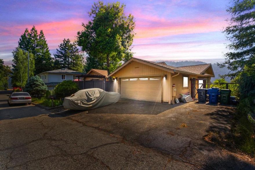 Welcome to your new home in Boulder Creek, just above the Boulder Creek Golf Course!  This character-filled home features high open beam ceilings with exposed wood in the kitchen, dinning and living rooms, with a floor to ceiling rock fireplace mantel that is boarded by a wood accent wall.  The light-filled space has spectacular views of the Redwoods and valley below.  Fenced decking in the front and long balcony out back provide nice, private, space for entertaining or just relaxing, an the lower portion of the yard gets great sun should you want to add some flower or vegetable beds for growing.  The fenced lower yard goes out beyond it's current boundary in the event you want more space for your green thumb or your pets, or keep it as it is and enjoy what nature has provided.   The home has 1,934 sq ft and offers 3 bedrooms, 2 baths.  Primary suite has a walk-in closet and a private bathroom featuring a large roll-in shower.  Secondary bedrooms are spacious, one with private entrance.  The kitchen is all electric, countertops in ceramic tile and plenty of wood cabinets to store all of your kitchen wares.  Laundry room is located off of the kitchen hall for easy access, and is equipped with electric hookups.  A little TLC and this home will be magnificent!
