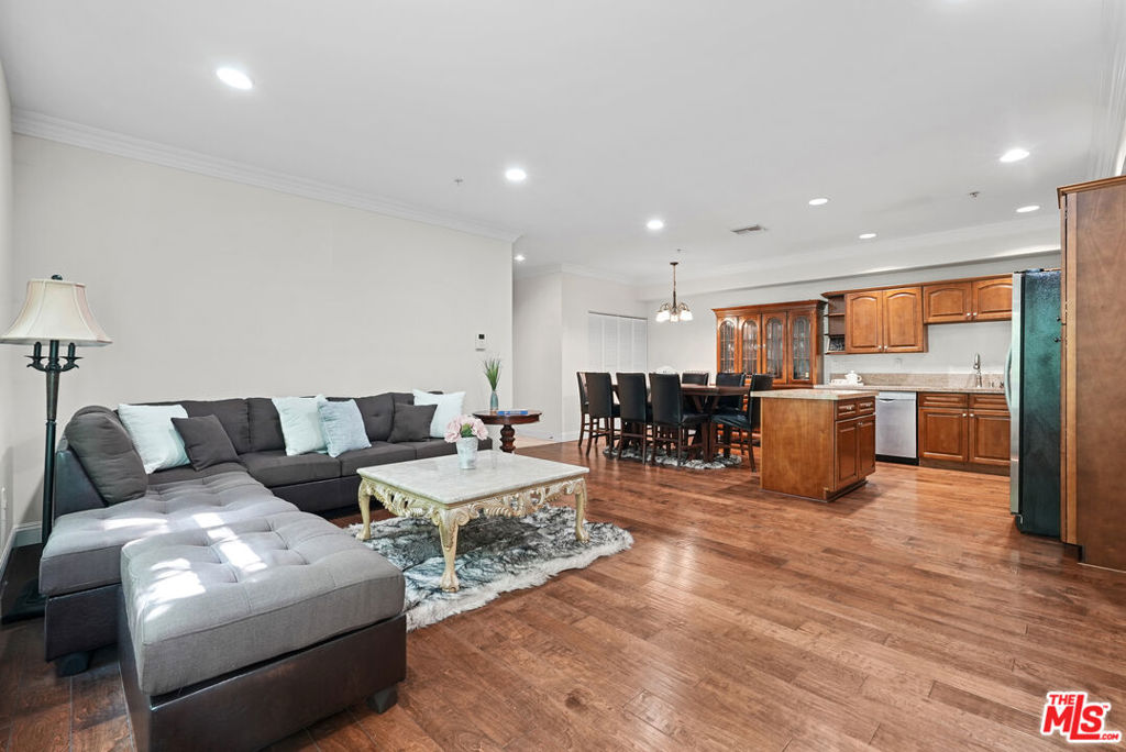 Discover urban sophistication in this stunning corner unit condo, perfectly positioned in the vibrant heart of Rampart Village. Built in 2010, this thoughtfully designed 3-bedroom, 2.5-bathroom home offers an impressive 1,490 square feet of contemporary living space featuring an open-concept floor plan with a gourmet kitchen showcasing premium granite countertops, stainless steel appliances, and rich hardwood flooring throughout. The unit includes three generously sized bedrooms, in-unit laundry for ultimate convenience, and a private balcony perfect for relaxation, plus side-by-side parking spaces in a secure, gated garage equipped with multiple EV charging stations. Situated in one of Los Angeles' most dynamic neighborhoods, residents enjoy close proximity to Downtown LA's business and entertainment districts, walking distance to Koreatown's renowned dining and cultural attractions, excellent public transportation connections, and abundant shopping and dining options. This rare offering combines modern amenities, prime location, and exceptional value in a secure, well-maintained building, making it perfect for professionals, investors, or anyone seeking the best of LA city living.