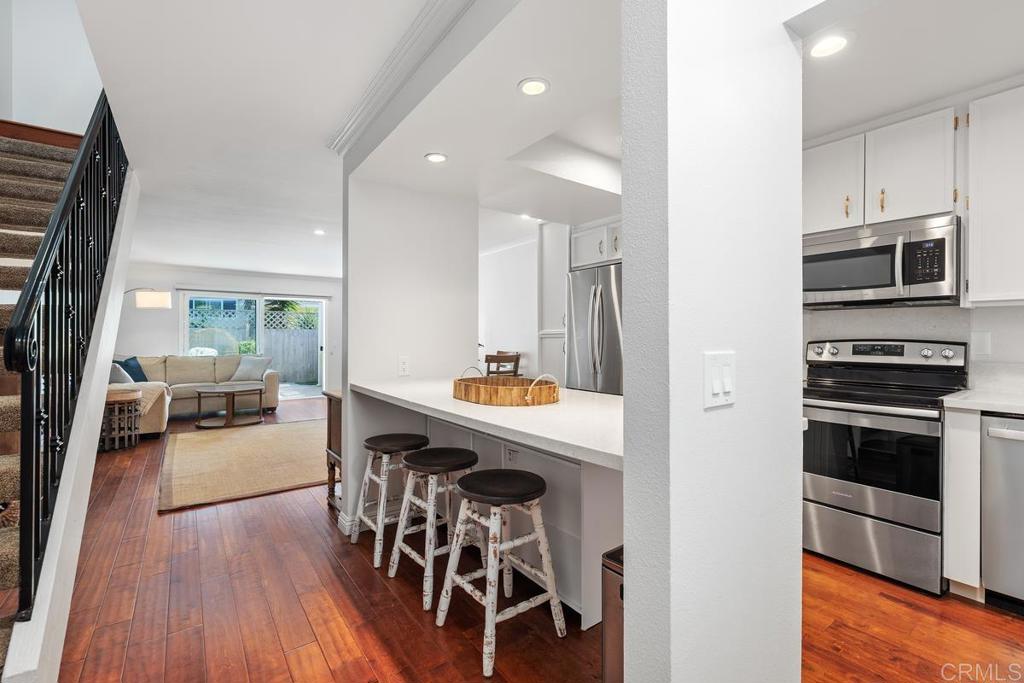 Tastefully updated 3 bedroom townhome in a prime Village Park location. Only minutes from the beach, surf and all that Encinitas coastal living has to offer. Features include shaker style solid core doors, hardwood floors throughout, mini split AC/Heat unit, plantation shutters, custom iron railing, recessed lighting, crown molding, whole-house fan, solar tube skylights, updated dual pane vinyl windows and a covered patio. The kitchen has been opened up creating additional counter space with bar seating and boasts stainless steel appliances, quartz countertops and plenty of storage. The bathrooms feature updated vanities with quartz countertops and tile floors. A separate laundry room is just outside the front door. The one car garage has storage cabinets plus overhead storage. Residents enjoy community amenities that include a pool, playground, tennis & pickle ball courts, and a popular dog park - all surrounded by lush greenbelts. Top rated schools are nearby along with shopping, restaurants, coffee shops and more. Don't miss this opportunity to own in one of North County's most sought after communities.