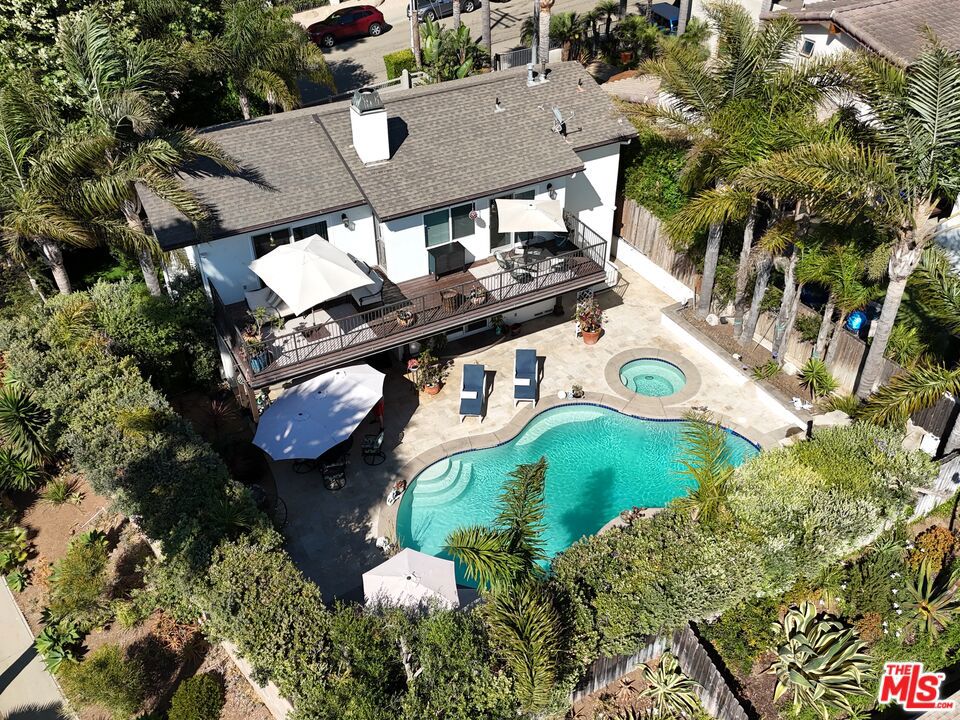 Welcome to this move-in ready gem in coveted Malibu Park, offering ocean views and a sparkling pool just moments from iconic Zuma Beach. Ideally located on a gated corner lot at the entrance to a quiet cul-de-sac, this 3-bedroom, 3-bathroom home offers the perfect blend of privacy, comfort, and coastal living. Step inside the formal dining room which flows seamlessly into a spacious family room and then opens to a backyard oasis complete with a pool, hot tub and waterfall. The updated kitchen features high-end appliances and is thoughtfully designed with a casual dining area and an inviting seating nook, perfect for gathering and everyday living. Upstairs, all three bedrooms enjoy stunning ocean views, with two of the bedrooms connected by an expansive deck, an ideal spot to unwind and take in Malibu's breathtaking sunsets. Perfectly positioned just down the street from the brand-new Malibu High School opening this August, Malibu Middle School, and directly across from Zuma Beach. You're also just minutes from Trancas Country Market, featuring charming local shops, dining, Vintage Grocers and live music every Friday night throughout the summer. Whether you're soaking up the sun by the pool, strolling to the beach, or enjoying the peaceful surroundings of this sought-after neighborhood, this home offers the ideal balance of location, lifestyle, and leisure the essence of Malibu living.