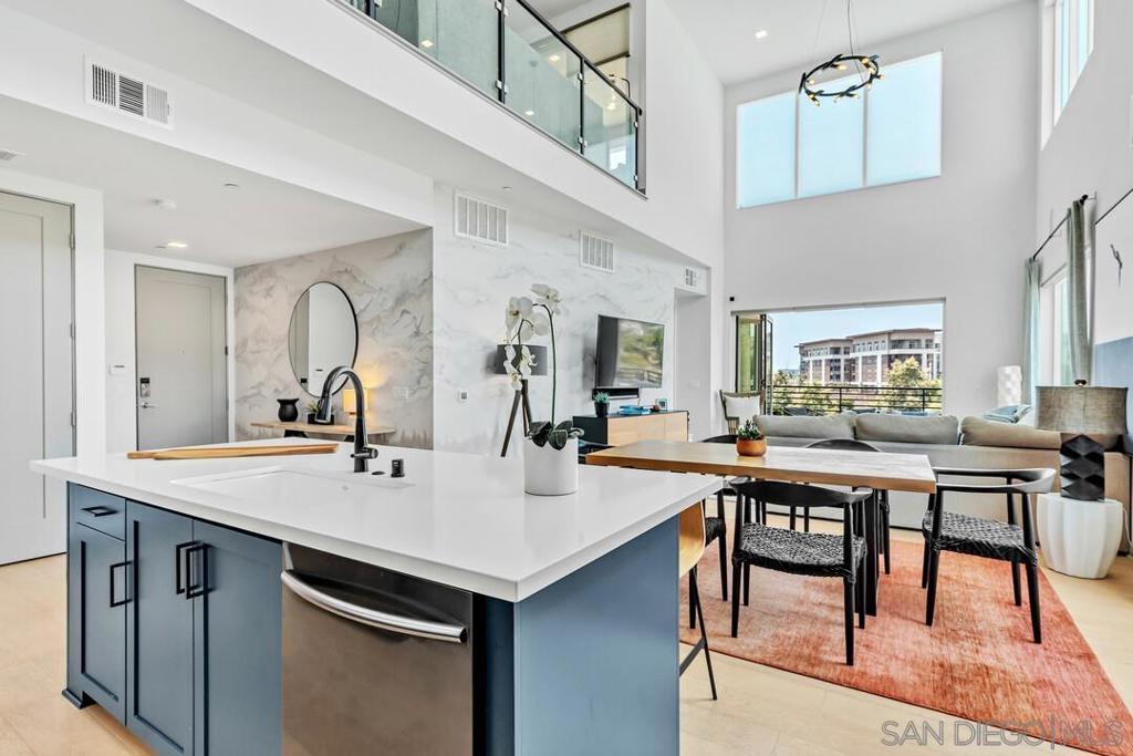 Welcome to one of the most coveted homes in Civita! This rarely available west- and north-facing penthouse at Elevate lives like a single-family home with the ease of lock-and-leave condo living. This was the model home that was originally designed to showcase every possible upgrade so it literally "has it all!" From the moment you walk in, you're greeted by soaring ceilings, walls of glass, and an open floorplan that feels both spacious and inviting. With a luxury office, a large loft and 2 fantastic outdoor patios with breathtaking sunset views, there’s plenty of room to live, work, entertain and unwind. The kitchen is equipped with and an oversized island that’s perfect for hosting or spreading out. Custom upgrades are found throughout, and the two-car garage and in-unit laundry closet give you the functionality of a detached home. Main floor custom upgrades include quartz counters, high-end appliances, handpainted, woodwork and stonework accent walls throughout, and bi-fold patio doors, streamlining the indoor and outdoor experience. Upstairs, the loft upgrades include custom cabinetry and shelving, built-in-bar with 2 top of the line wine refrigerators, glass pony wall, outdoor TV & gas fireplace. Too many upgrades to list everything! You’re just steps from Civita Park and the resort-style recreation center, complete with a pool, spa, clubhouse, and 24-hour gym. It’s truly vacation-style living in the heart of Mission Valley, close to everything yet tucked into a peaceful, thoughtfully designed community.