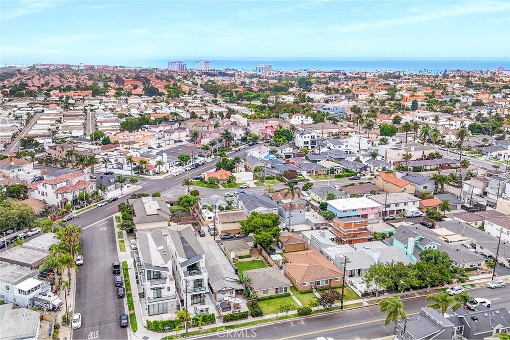 Stunning modern luxury home where glass, light, and ocean air shape each day in Huntington Beach. Surf at sunrise, bike the boardwalk at sunset, and savor Pacific City and Main Street. Refined architecture meets the easy coastal lifestyle that defines Surf City.
Approximately 3,364 square feet in total, the residence is served by an elevator to every level and framed by expansive upper front and rear decks with views that reach toward Newport Beach and the Angeles Mountains. The main living area is crafted for effortless entertaining, opening through a 10 foot corner sliding door to a front yard lounge with a gas fire pit. Inside, a sleek kitchen features top tier stainless steel appliances, custom countertops, a large center island, and a wine refrigerator, while glass railings, unobstructed balconies, and a glass railed staircase keep sightlines open and modern. An adjacent family room with a fireplace and flat screen television is ideal for gatherings. Modern window treatments give each room a tailored finish.
Parking is both practical and polished. An attached two car garage includes an epoxy coated floor with two additional parking spaces directly in front for added convenience.
The middle level balances privacy and flexibility with two secondary bedrooms for the main residence and an optional connection to the adjoining ADU. The ADU stands out at approximately 854 square feet with its own address, offering an oversized bedroom, a full kitchen, a bath, and two balconies. Keep it independent for rental income or integrate it for multigenerational living or long term guests.
The upper level is a private retreat. The primary suite rests under a vaulted ceiling with a fireplace and a spa inspired bath that feels resort worthy, featuring dual vanities, a separate glass enclosed shower with dual rain heads, a separate soaking tub, a smart toilet, and a built in custom closet designed for seamless organization.
With five bedrooms and five and one half baths, two full kitchens, and two separate addresses, this modern coastal home delivers rare flexibility and income potential. Expansive decks, refined finishes, and thoughtful amenities come together in a setting known for world class surfing, lively dining, and an outdoor way of life. All information deemed reliable but not guaranteed. Buyer and buyer’s agent to verify all information.
