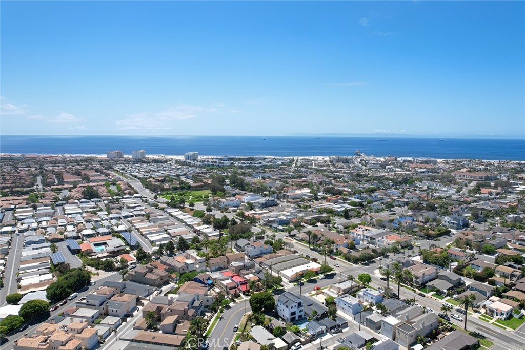 Stunning modern luxury home where glass, light, and ocean air shape each day in Huntington Beach. Surf at sunrise, bike the boardwalk at sunset, and savor Pacific City and Main Street. Refined architecture meets the easy coastal lifestyle that defines Surf City.
Approximately 3,364 square feet in total, the residence is served by an elevator to every level and framed by expansive upper front and rear decks with views that reach toward Newport Beach and the Angeles Mountains. The main living area is crafted for effortless entertaining, opening through a 10 foot corner sliding door to a front yard lounge with a gas fire pit. Inside, a sleek kitchen features top tier stainless steel appliances, custom countertops, a large center island, and a wine refrigerator, while glass railings, unobstructed balconies, and a glass railed staircase keep sightlines open and modern. An adjacent family room with a fireplace and flat screen television is ideal for gatherings. Modern window treatments give each room a tailored finish.
Parking is both practical and polished. An attached two car garage includes an epoxy coated floor with two additional parking spaces directly in front for added convenience.
The middle level balances privacy and flexibility with two secondary bedrooms for the main residence and an optional connection to the adjoining ADU. The ADU stands out at approximately 854 square feet with its own address, offering an oversized bedroom, a full kitchen, a bath, and two balconies. Keep it independent for rental income or integrate it for multigenerational living or long term guests.
The upper level is a private retreat. The primary suite rests under a vaulted ceiling with a fireplace and a spa inspired bath that feels resort worthy, featuring dual vanities, a separate glass enclosed shower with dual rain heads, a separate soaking tub, a smart toilet, and a built in custom closet designed for seamless organization.
With five bedrooms and five and one half baths, two full kitchens, and two separate addresses, this modern coastal home delivers rare flexibility and income potential. Expansive decks, refined finishes, and thoughtful amenities come together in a setting known for world class surfing, lively dining, and an outdoor way of life. All information deemed reliable but not guaranteed. Buyer and buyer’s agent to verify all information.