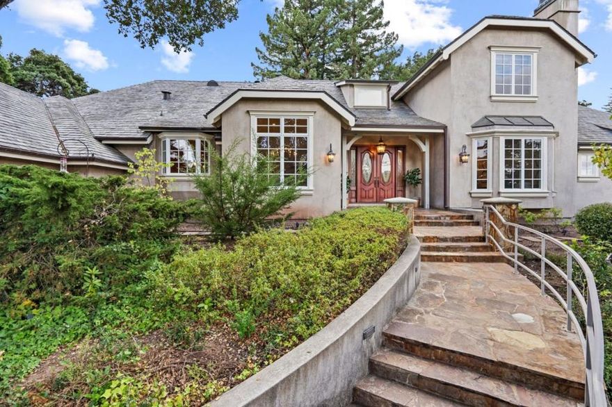 Escape to this stunning 4BD/4.5BA cul-de-sac retreat in the sought-after Carolands neighborhood of Hillsborough! Custom-built by the owners in 2007, this idyllic home offers 4 en suites, office, and hobby room. Surrounded by a natural park-like setting by landscape architect Michael Callan, admire lush gardens, fruit trees and the meditative sound of the fountain. Culinary delights await in the kitchen with BlueStar gas cooktop and Sub-Zero refrigerator. The formal living and dining rooms are perfect for elegant dinner parties, while the surround sound sets the ambiance for entertainment. Retreat to the spacious primary bedroom to unwind in the spa-like bathroom with jetted tub and steam room shower. This remarkable home includes 3-zone HVAC, Hunter Douglas shades, Anderson dual-paned windows, and slate roofing with copper gutters. With top schools & proximity to 280, this home offers the perfect blend of luxury and convenience. Experience this storybook estate firsthand. Welcome home!