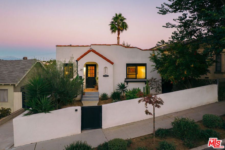 Perched on a quiet hillside street, 3306 Minto Court is a charm-filled Spanish retreat in the heart of El Sereno. From the moment you pass through the walled hacienda-style front garden, find yourself in a light-filled 2 bed/1 bath casita where classic architectural character meets the kind of thoughtful modern upgrades that make life easy. The living room exudes warmth and style: gleaming hardwood floors and wood-paneled walls lead to a built-in dinette area perfect for enjoying meals while gazing at views of the mountains beyond. Enjoy cooking in a fully renovated kitchen with stainless steel appliances, quartz countertops, and plenty of storage. Downstairs, past the dedicated laundry room, find a 132 sqft basement with built-in shelving offering a multitude of possibilities--a wine cellar for your favorite finds, or simply a dream space for organization and storage. Outside, find a fully renovated detached 180 sqft office space accented by elegant tile and French doors that open out onto lush greenery--an inspiring place to work, create, or host guests. The outdoor spaces are where the home truly shine. The current owners have transformed the yard into an entertainer's paradise: two separate fire pit lounges (chic outdoor furniture included!), string lights draping past mature avocado, pomegranate, and orange trees, and lush drought-tolerant plantings evoke resort-style living at its finest. Enjoy dining al fresco with friends and end your evenings curled up on the sofa with a drink and a blanket beside the fire. Practical upgrades make life here as effortless as it is beautiful: the home boasts fully paid-off solar panels that eliminate your electric bill, new roof on main house and office (2024), new electrical panel (2024), central HVAC, EV charging station, whole-house water filtration system, alarm system, double-paned windows updated with new flashing, and more. Located less than a mile from Rose Hill Park and the edge of Debs Park nature reserve, you're also centrally located to DTLA and all the hot shopping and dining in NELA (as well as El Sereno hot spots like Evil Cooks and lil'East Coffee). Don't miss your chance for the best of LA living at an unbelievable price--with its timeless architecture, modern conveniences and breathtaking indoor/outdoor balance, 3306 Minto Court will remind you why you fell in love with California in the first place.