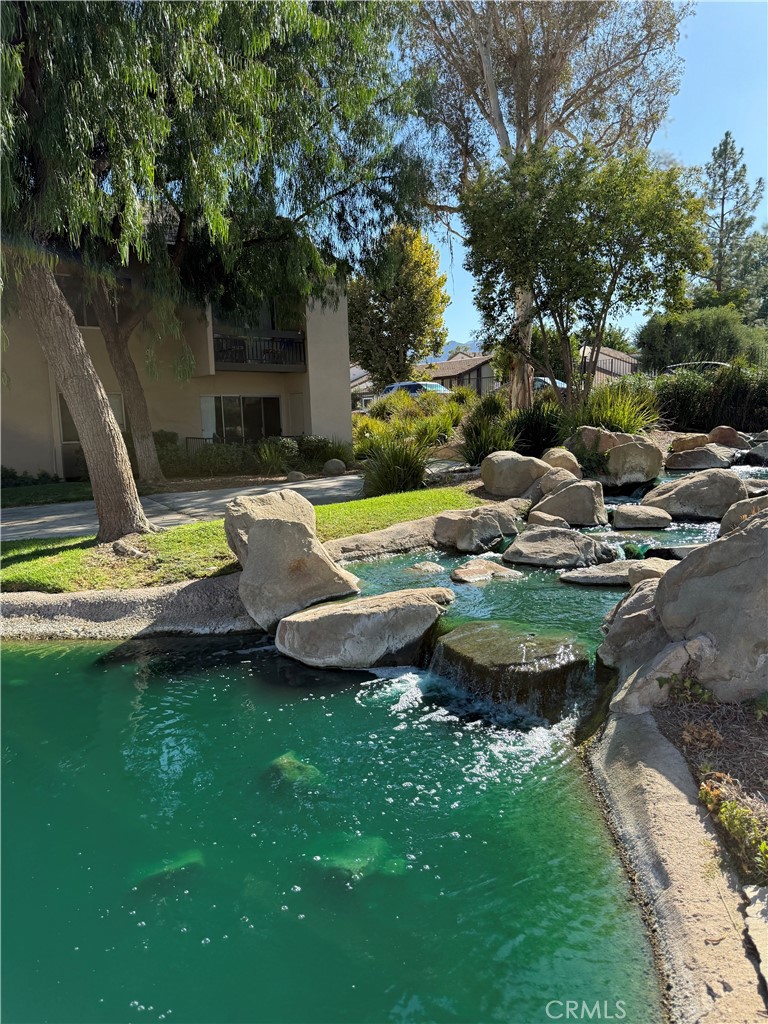 Beautiful Valencia Lakeshore condo, on the lower level with a view of the meander stream and boulder landscaping throughout Lakeshore. This home includes a spacious one bedroom & a nicely remodeled bathroom with a newer vanity & reglazed bathtub/shower and a large living area that is open to the kitchen.The updated features include a tasteful palate of colors & newer faux wood flooring throughout, updated windows and blinds, newer light fixtures, gorgeous granite kitchen counters and a breakfast bar. The kitchen also boasts a newer stainless steel 5 burner stove, microwave and dishwasher, a pantry for storage & a double stainless steel sinks. There is a triple wide closet and an additional double closet with mirrored doors in the dressing area. Enjoy this exceptional location which is nestled between the lake the sparkling rock waterfall which you can enjoy sitting outside on your patio with the lovely views! Parking includes one covered carport located next to gate entry to complex. Offering a lake, a pool and spa, a tennis court, playground and a community center, the Lakeshore complex is conveniently located close to Vista Valencia Golf Course, Cal Arts, College of the Canyons, shopping and restaurants and minutes from the I-5 freeway. Priced at $379,999 for one of the lowest prices on a Prime Valencia Location!!!!