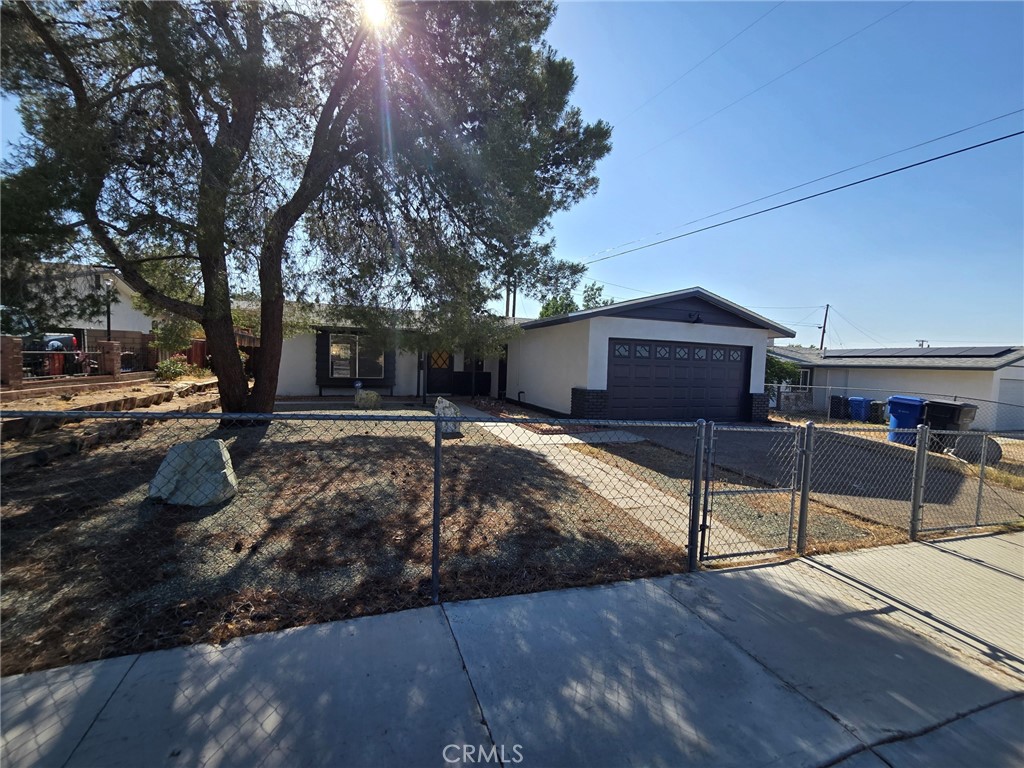 Step into this renovated gem ready for you to call home! This stunning 4-bedroom, 2-bathroom residence has both modern comfort and classic charm, making it ideal for you. Fenced front yard offers both privacy and curb appeal. Fresh, inviting interior, with brand new flooring and freshly painted walls that create a bright and welcoming atmosphere throughout. The spacious living area is perfect for gatherings as we prepare for the up-and-coming holidays, while the fully equipped kitchen features new countertops that make meal prep a joy. With brand new toilets and plush new carpeting in the bedrooms, every detail has been meticulously attended to, ensuring your comfort and convenience. A full-length patio invites you to savor the warm desert evenings. Picture yourself hosting barbecues, enjoying morning coffee, or simply relaxing under the stars in your private outdoor retreat. The fenced yard provides a safe space for pets to play freely. And let’s not forget one of the rarest finds in Barstow—central air conditioning! Beat the heat and stay cool all summer long while enjoying the comfort of your new home. Don’t miss this incredible opportunity to own a beautifully updated property that’s moving ready and waiting for your personal touch. Schedule your showing today and step into a life of comfort, convenience, and endless possibilities!