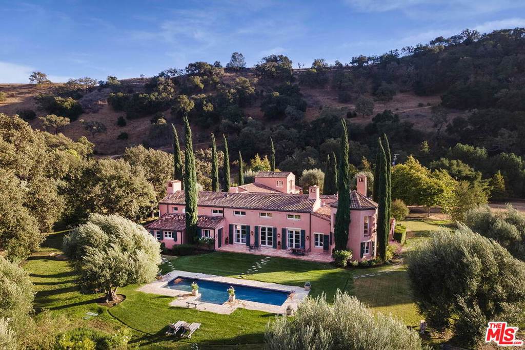 Italianate Villa, designed by Architect Peter Choate, set on approx. 102 acres in Happy Canyon area of Santa Ynez Valley. A courtyard entry accesses the approx. 5,907 SF residence. A great room, separated by an archway of antique wooden columns & vaulted beamed ceilings. French drs open to a courtyard, gardens & pool. The dining room is designed for entertaining on a grand scale or an intimate dinner by the FP. There is a prep kitchen, wine cellar & a half bath for guests. The library has a FP, wet bar & a spiral stairway to a loft. Master suite w/ FP, his & hers bath areas & closets. Two additional BRs, one w/ a fireplace, both en-suite baths. Sep quarters above two-car garages, pantry, storage & laundry rms. The boutique Sangiovese vineyard fronts a charming building that includes two horse stalls, 3 car garage & two study/craft room w/bath. Land & location are rare. This home is set in a meadow with a hillside oak forest. Perfect for the equestrian & outdoor sports enthusiasts.