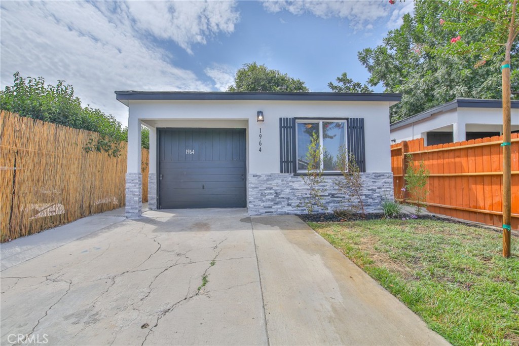Perfect Starter Home. Move in ready... Features include: 2 Bedrooms / 2 Bathrooms + Partially Converted Garage with a Kitchenette, Beautiful kitchen with granite counter tops, updated bathrooms, Tile flooring in Living room, Kitchen, and Baths, New Carpet in Bedrooms. Uncovered driveway parking. Alarm on property, Freshly painted interior and exterior. This is a must see!