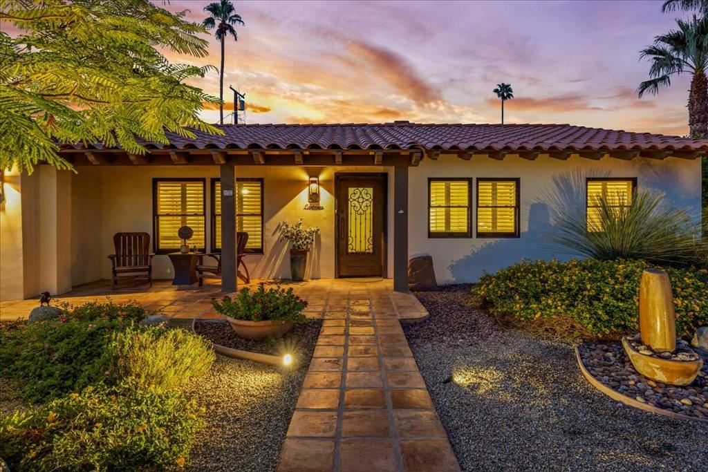 Welcome to Casa Lantana in highly desirable Movie Colony East, one of Palm Springs' most iconic neighborhoods--where history, style, and desert living all come together in perfect harmony. Discover the perfect blend of vintage charm and modern comfort at this timeless Palm Springs Spanish Retreat. The charm begins at the covered front porch and continues as you pass through the custom iron front entry door. Featuring 4 Bedrooms (one currently used as an office has its own en-suite bathroom), a master bedroom with en-suite, and two additional guest rooms. Custom closet organization systems in the primary bedroom and two of the guest rooms. All Showers are beautifully tiled with custom glass doors/surrounds and the master bath has dual vanities. Granite counters, Viking appliances and a wine fridge complete the amazing kitchen. Inside laundry room with ample storage. Custom shutters throughout and interior and exterior were painted in 2020. The large Great room features tongue and groove ceiling and open beams with French doors leading to two distinct outdoor spaces. Each side has a large covered patio and distinct entertaining space offering endless opportunities to entertain or unwind. One side includes Mountain Views and the sparkling Salt water pool and Spa with new pebble tech and all new equipment. Recently upgraded with new Cool Decking with diamond grind surface. Heated pool and spa with additional roof mounted solar pool heater providing eco-friendly year-round enjoyment. The other side includes a treed garden and illuminating fire pit . A large side yard with desert plants, meandering flagstone walkway and drought tolerant landscaping with automated irrigation make for easy maintenance. The property is walled for privacy and includes a 1 car garage with built in storage cabinets and Granitex epoxy flooring surface. A new tankless water heater was added in 2024. Dual HVAC and ceiling fans throughout for energy efficient heating and cooling. Whether it's a lively gathering under the desert skies or a quiet morning coffee in your private oasis, this home was designed for the Palm Springs lifestyle. Living in Movie Colony East means being close to it all. You're just minutes from downtown Palm Springs, with world-class dining, boutique shopping, and vibrant nightlife. A short walk to Ruth Hardy Park for tennis, pickleball, or a picnic under the palms--or simply enjoy the peace and quiet of wide streets and a welcoming neighbor