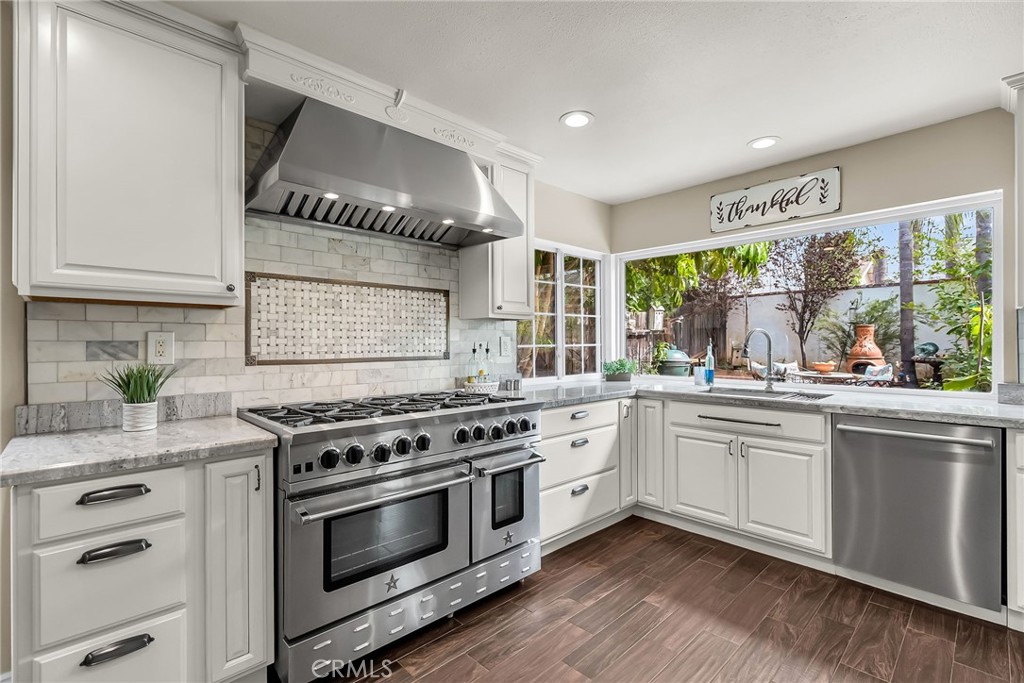 Nestled in Corona's coveted west side, this stunning home welcomes you with timeless charm and modern comfort with two primary suites. As you approach, a classic white picket fence frames the property, complemented by vibrant, friendly plants that create an inviting first impression. Discover unparalleled elegance in this beautifully updated 2,575 SF home. This open and airy residence, offering everything you’ve been searching for.
Step into a bright interior showcasing a neutral paint palette. The remodeled bathrooms feature contemporary fixtures, elevating everyday living. The expanded floor plan welcomes you with a formal entry and cozy sitting area, flowing seamlessly into a formal dining room adorned with a fireplace and skylights. The chef’s dream kitchen, bathed in natural light from expansive windows, boasts top-tier upgrades, including an 8 burner Blue Star range with double ovens, perfect for culinary enthusiasts. Soft close drawers and cabinets. The cabinets have pullout shelving. The pantry has a hinging rack for extra storage.
The living room impresses with soaring cathedral ceilings, while the massive upstairs bonus room with a private balcony offers endless possibilities. Retreat to the luxurious upstairs primary suite, complete with a stunning bathroom featuring dual sinks, a deep soaking tub, and spacious shower. Three additional main-floor bedrooms provide ample space for family, guests, or a home office.
Outside, enjoy a charming front patio with a white picket fence, ideal for morning coffee. The expansive backyard, complete with a gazebo, plants and lawn, is perfect for entertaining or relaxing.
Nestled in an ideal commuter location, this home is just minutes from schools, shopping, dining, and freeway access. Don’t miss this rare opportunity to own a Corona masterpiece!