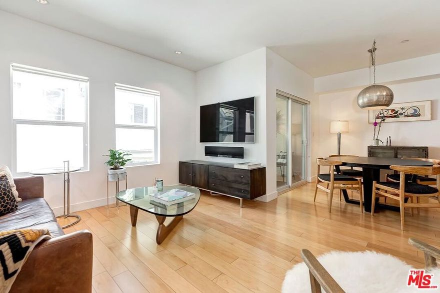 Step into luxury living with this exquisite 1-bedroom, 1 1/2 bathroom sanctuary nestled in the vibrant heart of West Hollywood. This luminous top-floor unit spans two levels, offering a seamless blend of style and comfort. The first level boasts a spacious living area with natural light, dining room, and powder room. A chef's dream kitchen featuring Caesarstone countertops, custom wood cabinets, and high-end stainless steel. Descend to the lower level where serenity awaits in the primary suite, complete with a generous walk-in closet and an indulgent bathroom featuring double sinks. An additional versatile space awaits, ideal for a home office or personal gym. Enjoy the ultimate outdoor experience with expansive patio spaces on both levels, providing the perfect setting for al fresco dining or simply soaking in the California sunshine. Top floor corner unit with only one shared wall. This residence also boasts modern conveniences such as central HVAC, an in-unit washer/dryer combo, and a reverse osmosis water filter. Revel in the finer details including beautiful hardwood floors, recessed lighting, and double-paned windows and sliding doors. With two tandem parking spots and low HOA fees, this is West Hollywood living at its finest. Close to Sunset Blvd's shopping, dining, and entertainment.