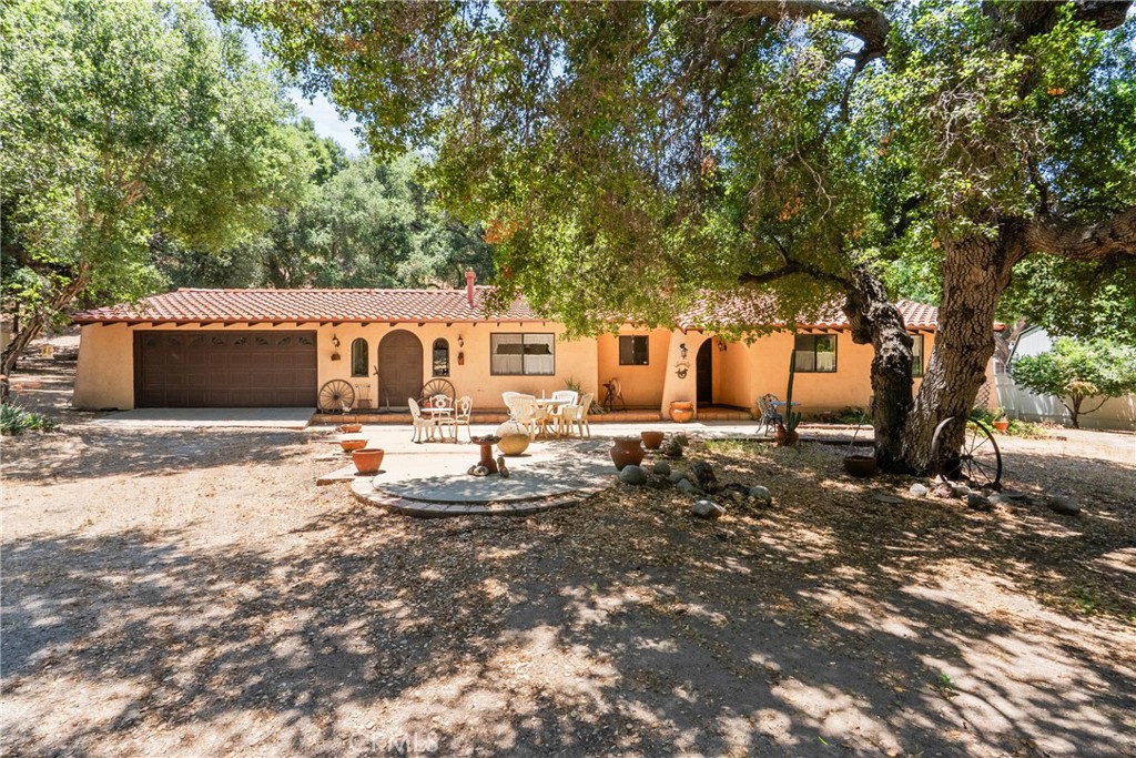Craving serenity without sacrificing access to the city? A short drive to Valencia, freeway access and shopping near, this Spanish-style estate offers a peaceful lifestyle on 5 scenic acres. Work remotely surrounded by nature, unwind by one of two fireplaces, or sip your morning coffee in the enclosed patio as birdsong fills the air. With spacious bedrooms, a formal dining room, and stunning Spanish tile throughout, this property is your peaceful oasis away from the grind of city life.