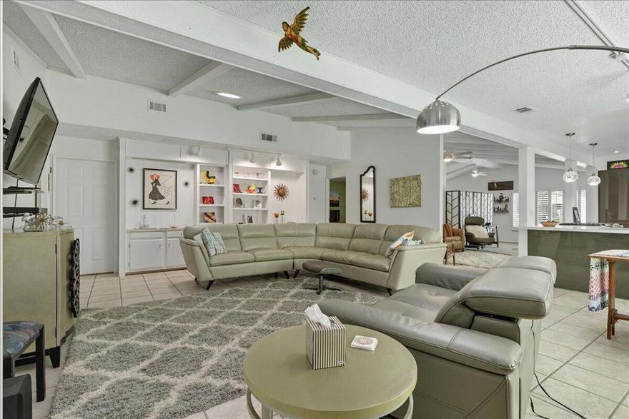 Contemporary & spacious Desert Oasis awaits its new owner.  55+Gated Golf Country Club living.  Over 1900',this home has a great open floor plan with vaulted ceilings, dry-wall, gorgeous remodeled kitchen, large family room, 2 primary bedrooms with their own baths, attached 2-car garage & a wonderful backyard.  The gourmet kitchen has been recently remodeled with designer cabinets, quartz counters & Island, stainless steel appliances.  The recessed & custom lighting with the modern charcoal cabinetry is stunning.  The kitchen is open to both the formal dining or extra lounge area and a large great room with custom cabinetry, plantation shutters, wet bar & track lighting.  The entry way living room is currently an artist retreat with plantation shutters, high ceilings & windows looking out to the landscaped front yard.  You will love the primary bedroom with double walk-in closets & the remodeled bath with recessed lighting, tile shower, dual sinks & quartz counters.  Guests will love the privacy of their own en-suite bath as well.  Plenty of room in the laundry with sink, storage & room for your computer work station.  The backyard is special! A private Oasis with covered patio enclosed with sliding screen doors opening to the lovely garden area shaded by a private ficus hedge.  Plenty of room for your canine or feline pals.  A special bonus - At one end of the patio is a separate custom Arts & Crafts Studio - And don't forget the 2-car garage with plenty of extra storage room.  Portola CC is an active community with pickle ball courts, 3 pools, newly remodeled clubhouse with Pub & a beautiful 18-hole par three golf course where play is included in the low HOA fee.  Home is on a permanent foundation for ease of financing.  You also own your land in Portola which protects the future value of your home.  Great location near all the shops & restaurants of El Paseo, Palm Desert Community Park with shaded walkways, ponds, & dog parks. Close to McCallum Theatre with its year-round shows & entertainment & nearby Eisenhower Medical Center.  Come take a look at why so many are choosing Portola CC as their choice for a great Desert Living lifestyle.