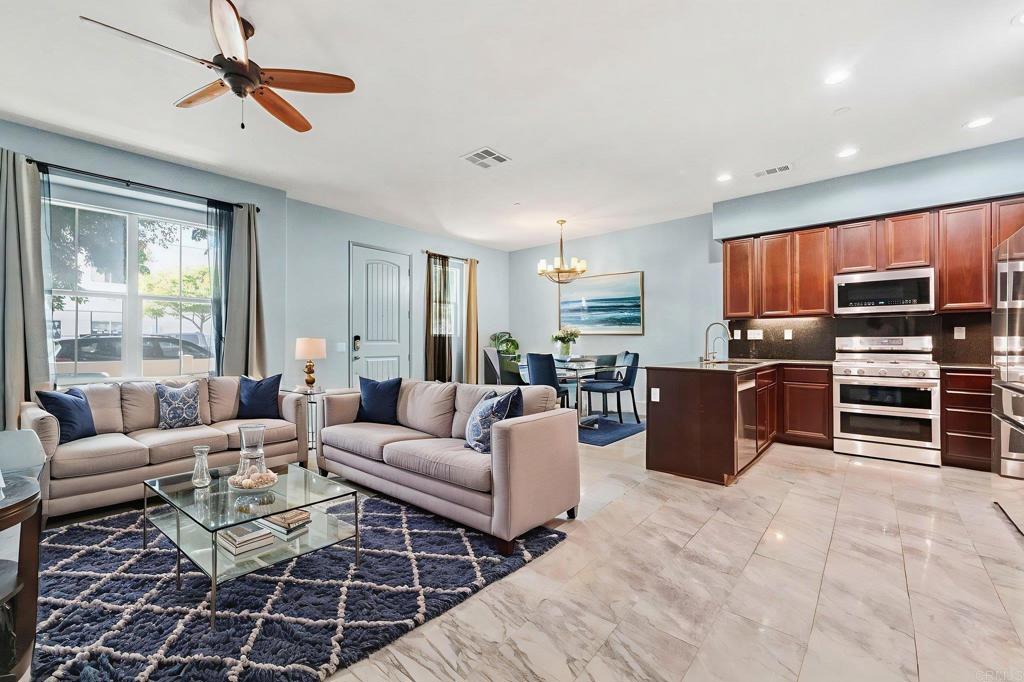 Located in the sought-after community of Montecito in Otay Ranch, this stunning 4-bedroom + loft, 3.5-bathroom property offers style and functionality. Equipped with solar, a reverse osmosis and water softener system, and many upgrades, this home is move-in ready. Welcome yourself into the open-concept main floor where the living room flows seamlessly into the kitchen. The kitchen features cherry oak cabinets, granite countertops, newer stainless steel appliances, a large walk-in pantry, and access to the 2-car garage with epoxy flooring. A half bath is located on the first floor, ideal for guests. Upstairs, the primary suite boasts a massive walk-in closet, a highly upgraded en-suite bathroom with enhanced shower and tub for extra comfort. Additionally you’ll find two additional bedrooms, a shared bathroom, and a laundry room for efficiency. The third floor features a spacious loft, a fourth bedroom and a full bath—perfect for a guest space, office, or rent out for additional income. Other upgrades include bathrooms with cherry oak cabinets, custom countertops, upgraded showers, and oversized bathtubs, tile and laminate wood flooring, ceiling fans in every room, A/C, and cherry oak-stained staircase railings with iron rods. Enjoy the outdoors in your private patio space. Montecito’s resort-style amenities including pools, spas, a fitness center, sports courts, and a clubhouse. Conveniently located across from an elementary school and park.