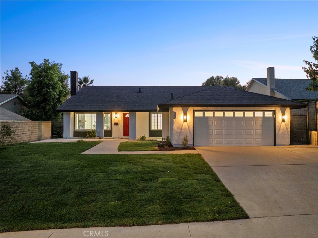 Exuding elegance and modern design, this fully remodeled 4 bed 2 bath 1,750 sq ft residence showcases an inviting open concept layout that seamlessly connects the living room to the chef’s kitchen. Upon entry you are greeted by soaring cathedral ceilings and a dramatic floor to ceiling black shiplap fireplace with a rustic wood mantel and sleek electric insert, setting the stage for the home’s sophistication. The kitchen offers an abundance of counter space with a large breakfast bar perfect for gatherings, along with quartz countertops, subway tile backsplash, stainless steel appliances, a microwave conveniently placed in the island, and dual pendant lights accenting the designer vent hood and cabinetry. A central flex space with built in desk complements three spacious bedrooms and a guest bath with chic black fixtures, tiled tub shower, and glass enclosure. The expansive primary suite offers abundant natural light, a massive walk in closet, and a spa inspired bath with dual sinks, frameless glass shower, and decorative flooring. With newer roof, plumbing, electrical, dual pane Milgard windows, fresh white exterior paint with black trim and red door, lush newer sod in the front and backyard, a two car garage, and a private backyard with shade bar patio cover, this home combines style and comfort in a prime location near award winning schools, shops, restaurants, and the new Sand Canyon Village all with no HOA and no Mello Roos just off the 14 freeway.