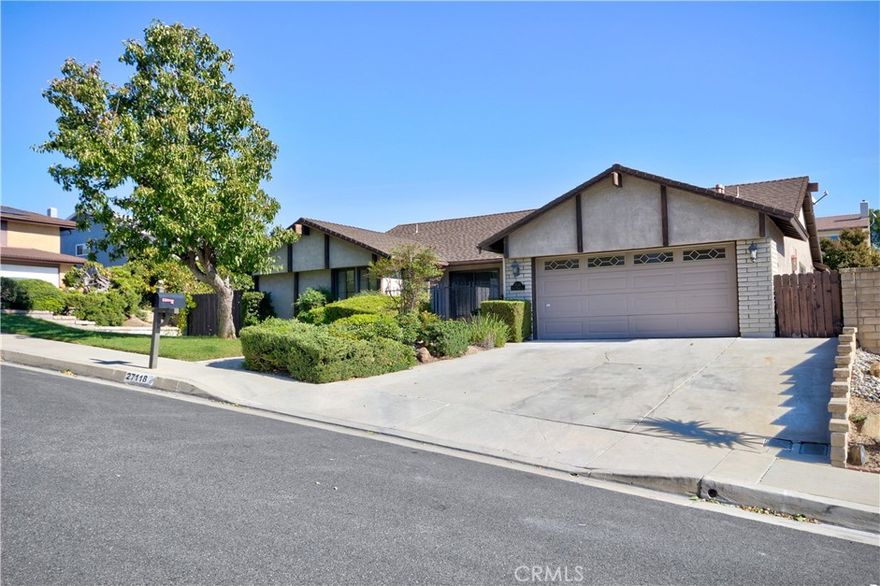 North Valencia 4 bedroom, 2 bath pool/spa home on a large corner lot. Courtyard entry leads to a spacious living room with a cozy fireplace. Formal dining room connects to bright kitchen featuring a breakfast nook, quartz countertop, stainless steel fridge and ample cabinets. Family room featuring plantation shutters is perfectly located with direct access to large 2 car garage. Primary en-suite bedroom has direct access to the vey spacious rear yard. Spacious home features laminate flooring and tile flooring through, recessed LED lighting, smooth ceilings and is freshly painted throughout.