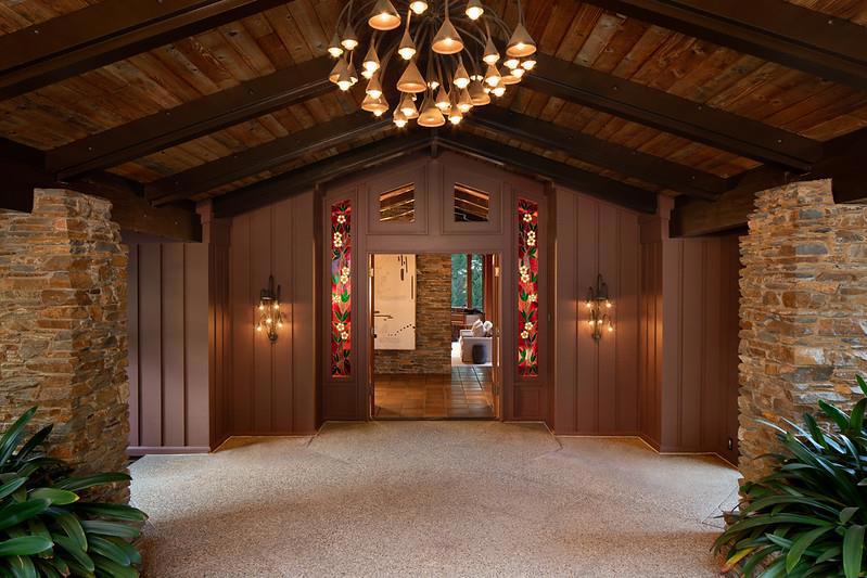 Set on 3.4 acres in central Woodside bordering the 75-acre Fleishhacker Estate Conservancy this home was designed by renowned architect Goodwin Steinberg. Organic appointments that include copper chandeliers by Albert Guibara, stained glass windows by Hermann Lirk, and walls in clear vertical grain cedar and stone. Exceptional spaces for entertaining plus two separate offices for remote work. 4 bedrooms include a luxurious main-level primary suite + lower level w/3-bedrooms, including an en suite, central play area, large storage area or potential fitness room, & wine cellar. Upgraded 400 amp service including Tesla charger. Beautifully landscaped grounds, originally designed by Thomas Church, with enchanting gardens, inviting courtyards, open meadows, and a wraparound deck overlooking the sun-drenched pool. A private nature trail winds around the inside perimeter of the fenced property. Just over a mile from the Town Center. Highly-regarded Woodside School (K-8).