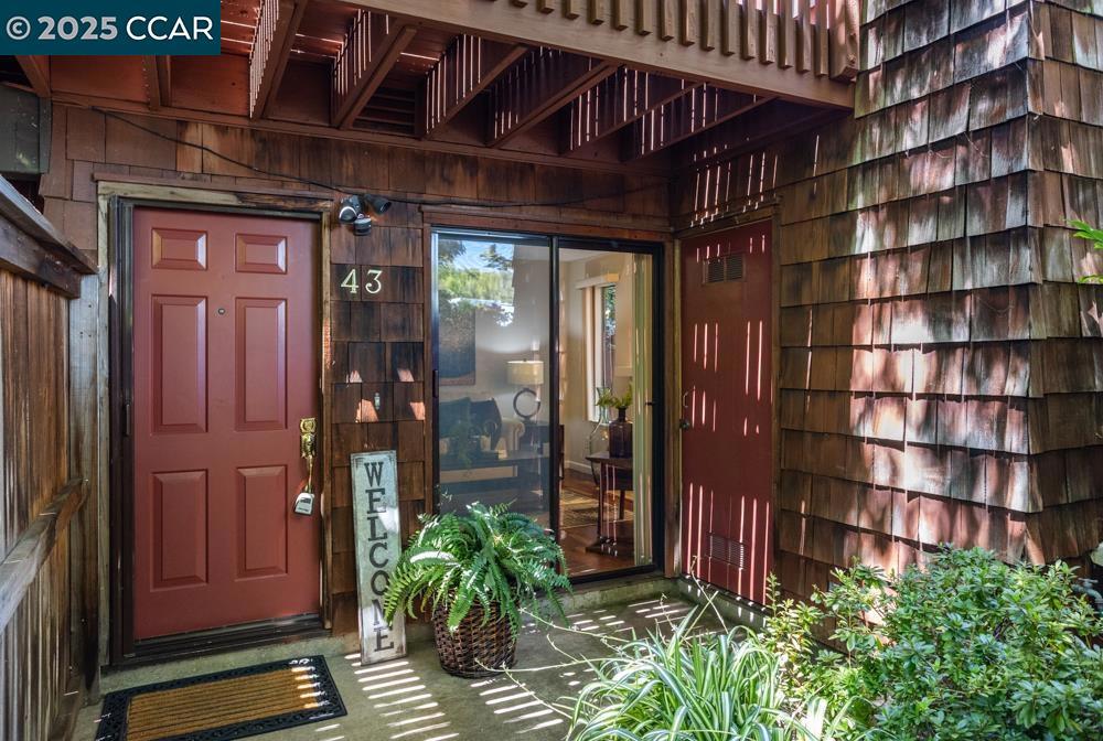 Open House 1-5p 8/16 & 8/17. A special place to call home. End unit on ground floor with private front courtyard. Only a small step entry, naturally cool & shaded by a canopy of trees. Great layout with 2 berooms, 1.25 baths with sink in primary bedroom with french door to enclosed and private rear patio. 2nd bedroos with sliding glass patio door. This home boasts an excellent floor plan featuring a spacious living room with a cozy fireplace, a welcoming entry, and a dining area with ceiling fan & light all open to the kitchen. The kitchen is enhanced by granite counters, light -colored cabinets with ample storage and pantry. The community offers serene, mature landscaping and a refreshing swimming pool. Coveted private access to Newhall Community Park.