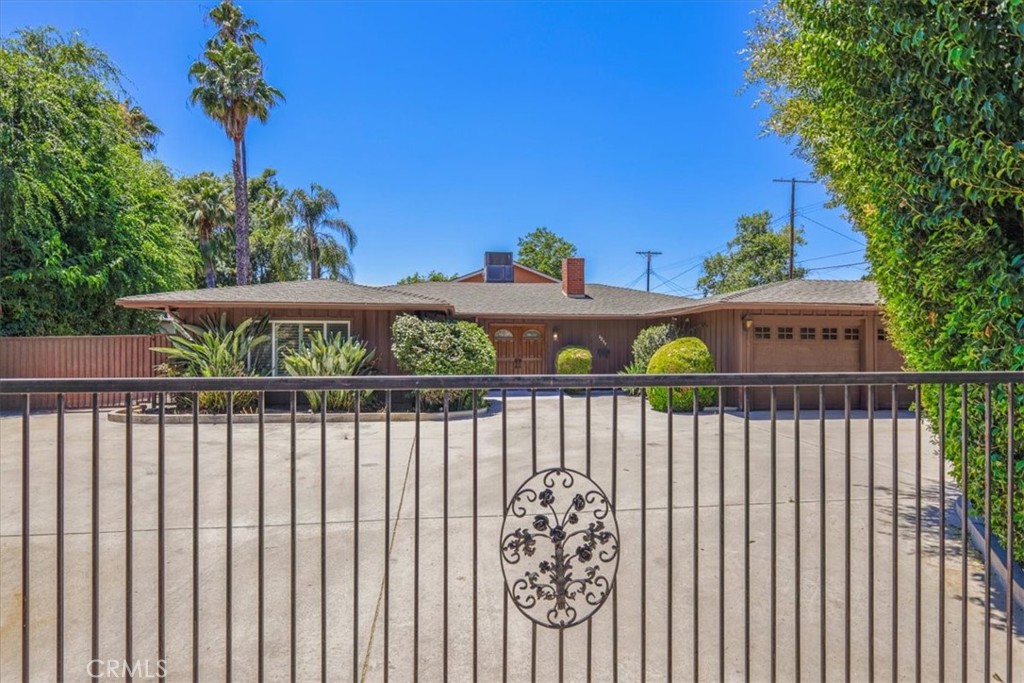THIS SPRAWLING "ONE-OF-A-KIND" ranch home is nestled on a picturesque street in the heart of Valley Glen, and as soon as you lay your eyes on it you'll immediately recognize the owner's true "Pride-Of-Ownership." Here are just a few of its many other fine features:Lush privacy landscaping and groomed shrubbery welcome you. Custom front doors open to a flowing 2,541 square foot open concept floor plan that is in "Move-In-Condition" with majestic wood beamed ceilings and easy care wood grained tile flooring. The huge living room has a gas-burning brick fireplace with raised hearth. The family's cook will appreciate the kitchen's recessed and custom pendant lighting, abundant cabinets with counter lights, ample stone counters with full back-splash deep basin farmhouse sink, built-in stainless steel appliances, built-in breakfast bar, and the convenience of the adjoining dining area with serving pass through counter. The spacious den with its direct patio access flows seamlessly with the dining area. The huge family room has a larger bar and and adjoins the recreation room with its direct patio access making them perfect for entertaining. 3 bedrooms; The grand suite has a wall-to wall mirrored closet, a walk-in closet and a beautifully appointed bathroom with dual sink mirrored vanity and glass enclosed shower. A total of 2.5 bathrooms; The 1/2 bathroom has easy backyard access making pool wardrobe changing easy. Functionally located laundry room. The energy efficient dual pane windows with plantation shutters will help keep your utility bills low and the interior quiet. 2024 installed HVAC system for year-round comfort. Copper plumbing. You're going to enjoy the backyard's covered patio with fire-pit, and the sparkling pool. You'll have absolutely no problem parking any and all of your vehicles, RV and any other toys on the gigantic concrete driveway or in the 3 car direct access garage, all behind the automatic security gate. all of this is nestled on a large 11,901 square foot lot that's close to shopping, Costco, Balboa Park with its boating lake, comprehensive sports facilities, golf course and activities, plus easy access to the 101, 170, and 405 freeways. Call now for all of the details and I'll gladly arrange your private tour.