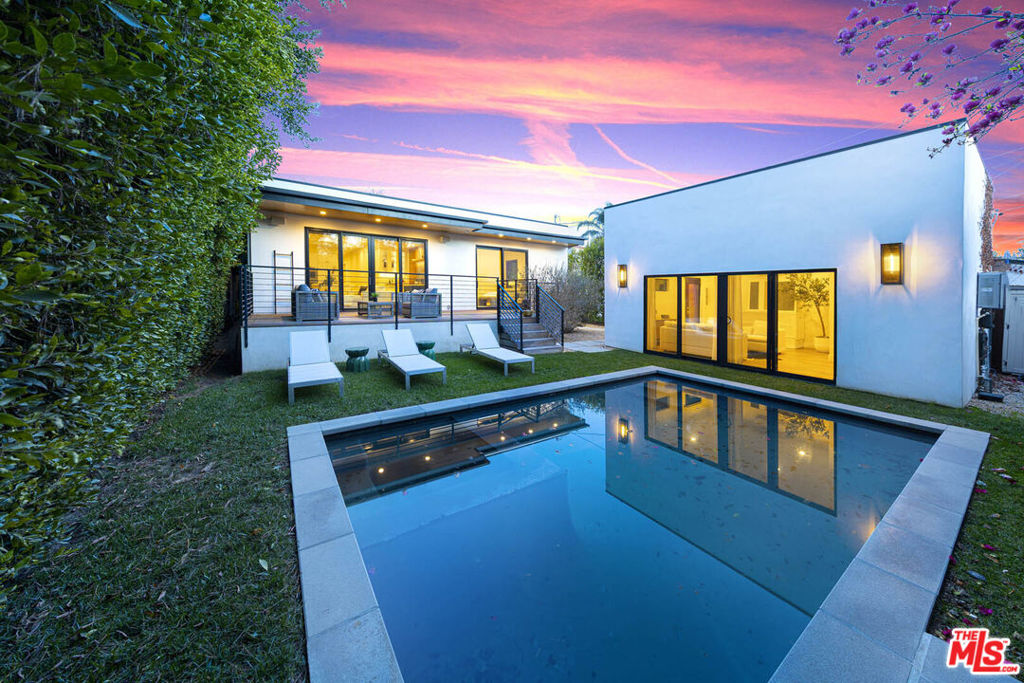 You Can Have It All at 123 & 125 S. Kilkea Drive. A home with guest house/ADU that proves elegance and ease, luxury and livability, privacy and prime location does not have to be a trade-off. You truly can have it all! Tucked behind tall privacy hedges on one of the most picturesque, walkable streets in Beverly Grove, this single-story modern farmhouse feels like a private resort compound in the middle of the city. Built by a Trousdale Estates builder, the home delivers the exceptional craftsmanship and refined details typically found in Beverly Hills yet offered here at a rare value. From the moment you arrive, a sense of calm and sophistication sets in. Step through the oversized 9-foot pivot door and enter a sunlit space where wide-plank white oak floors, 10-foot ceilings, and warm modern finishes invite you to relax and stay awhile. The thoughtful layout flows effortlessly from formal living to dining, kitchen, and family room, creating spaces that are both elevated yet utterly comfortable. At the heart of the home lies the stunning entertainer's kitchen, anchored by a 12-foot double waterfall island with seating on both sides. With custom cabinetry, a walk-in pantry with pull-out shelving, high-end appliances, and designer brass hardware, this space was made for connection whether you're cooking for two or entertaining a crowd. Adjacent, the family room is layered with texture and intention: a striking architectural wall blending wood and tile, a built-in wine rack, space for a wine cooler, floating shelves illuminated by soft LED lighting and a focal fireplace. The result is a stylish, yet relaxed atmosphere conveyed throughout the residence and grounds. The primary suite is a true retreat, featuring two artfully lit walk-in closets with built-in LED accent lighting that make the space feel like a luxury boutique where you can relax while surrounding yourself in a beautiful space with your favorite things. The spa-like bath completes the retreat with its clean lines, elegant finishes, and calming palette. Once outside, your private outdoor oasis continues. The backyard offers a seamless blend of deck, pool, spa, and green space. All framed by mature hedging that enhances the feeling of exclusivity. Whether relaxing in the sun or hosting under the stars, the space is designed for year-round enjoyment. Adding flexibility and long-term value is a fully detached guest house/ADU complete with its own address, bath, and kitchenette. Use it as a private guest suite, gym, studio, or WFH office, the possibilities are endless. There is also a dedicated laundry room offers ample storage with abundant cabinetry, a deep utility sink, and plenty of space to keep daily routines organized and out of sight. Other highlights include: 8-foot solid-core interior doors, Jeld-Wen windows, The Shade Store motorized window treatments, Linear slot A/C vents, Sonos sound system, plus a rare 100 sq ft California basement for additional storage. Completed in 2022, 123 S Kilkea is more than just a home, it's a turnkey lifestyle, where every detail has been curated for comfort, beauty, and ease. Whether you're seeking a forever home, downsizing in style, or upgrading to refined single-level living, this property is the one you've been waiting for. Here, you're just moments from the best of Melrose, West 3rd, and The Grove, with a 94 Walk Score and a vibrant neighborhood allowing you to relish the benefits of a city lifestyle while creating community roots. This is where form meets function. Where luxury meets livability. Where privacy meets location. This exceptional home is where you can have it all.
