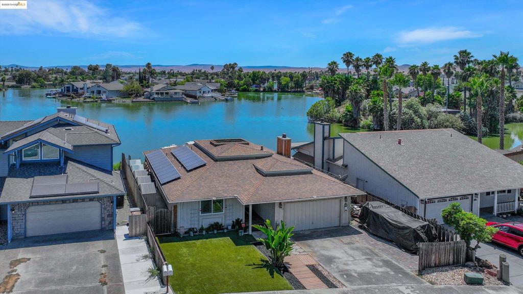 OPEN HOUSE 8/2/2025 12p-2p. This three bedroom, two bath Discovery Bay home is ready for your design and renovation skills to make it your very own! The property is located in a quiet cul-de-sac and sits on the serenity of the lake. The kitchen is equipped with stainless steel appliances including 4 ovens, a baker's dream. Relax in the tranquility of the back deck where you will enjoy the wonderful breeze and shade in the afternoon. Enjoy paddle boarding, swimming, kayaking, sailing your electric powered sailboat or fishing right off the dock in your own backyard!