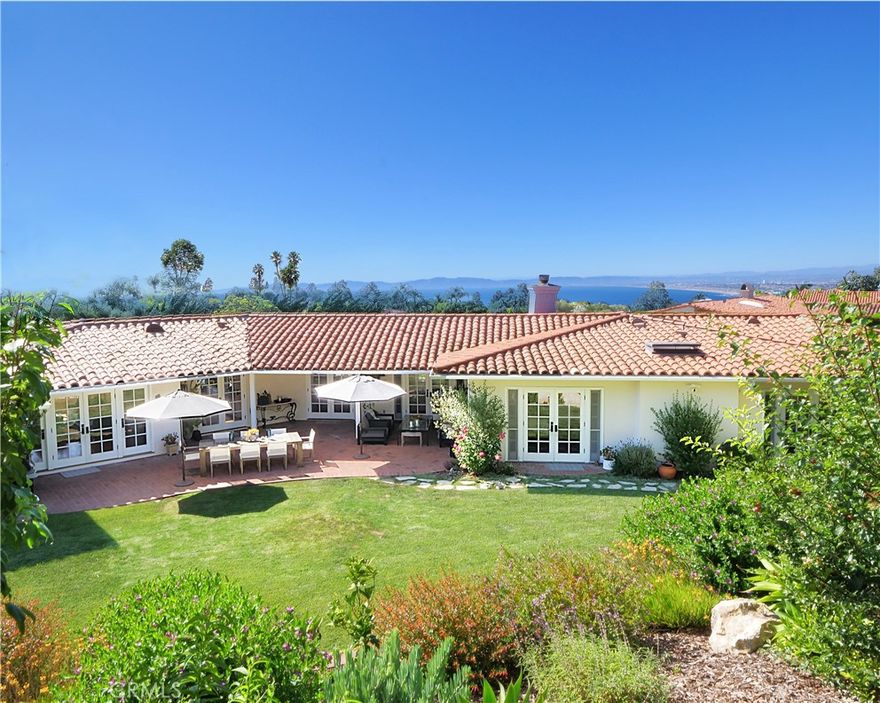 The classic Coastal Spanish estate you’ve been dreaming of has arrived. Perched high atop Palos Verdes Estates on a half-acre lot, this single-level home captures breathtaking coastline views stretching from Malibu to the Hollywood Sign.



Designed in timeless ranch style, the residence features 3 bedrooms plus an office (optional 4th bedroom) and 5 bathrooms. French doors line the home, opening to a private backyard ideal for barbecues, entertaining, or unwinding on the serene “Queen’s Necklace Viewing Deck.”



One of the most captivating highlights is the expansive rose garden, complete with a charming gazebo—perfect for morning coffee or evening relaxation. This versatile area also offers the potential for a future pickleball court or resort-style pool.



Interior spaces include two spacious living rooms with ocean and garden views, a formal dining room, and a primary suite with dual vanities, soaking tub, and separate shower. Two additional guest suites feature en-suite baths, and a dedicated office provides flexibility.



Additional features include hardwood floors throughout, central air conditioning, a large circular driveway, and an attached two-car garage. The home has been substantially refreshed and restored by the current owner, offering a true move-in-ready opportunity.



Located within the award-winning Palos Verdes School District and minutes from the beach, this estate offers endless opportunities to embrace the coveted Palos Verdes lifestyle.