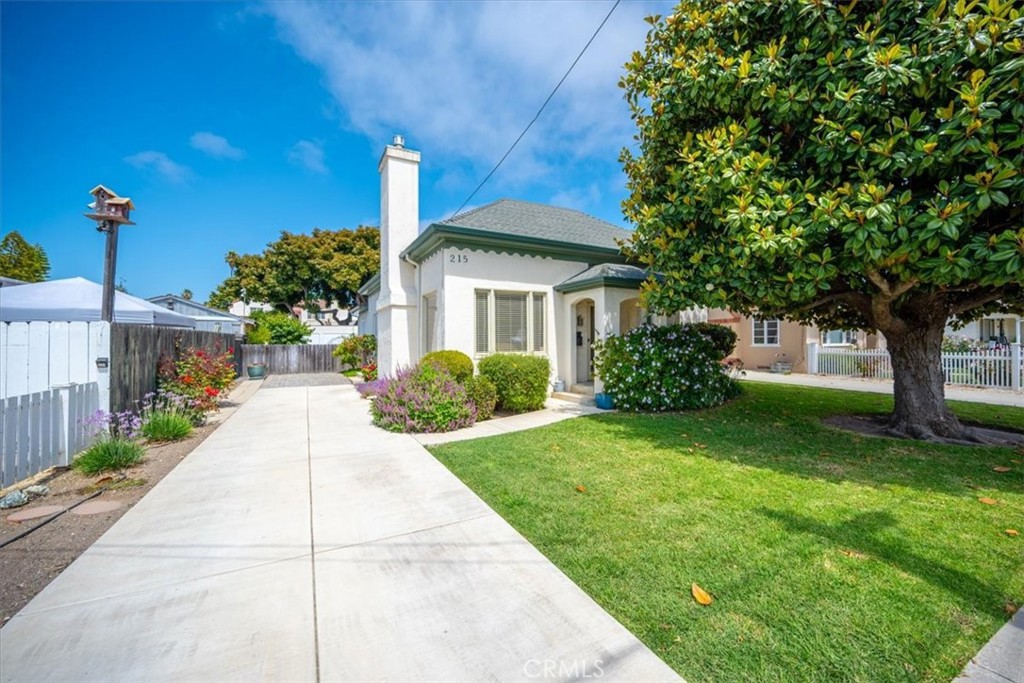 Step back in time with this enchanting vintage home, ideally situated just a short stroll from the historic Village of Arroyo Grande. This gem exudes timeless appeal with its original hardwood floors that flow throughout, hinting at stories from a bygone era. Imagine waking up and taking a leisurely walk to your favorite local coffee shop, browsing unique boutiques, or enjoying an evening out at one of the many restaurants and lively bars – all without needing a car. The prime location offers an unparalleled lifestyle of convenience and community. Inside, the home retains its classic character, offering a warm and inviting atmosphere. Outside, there is ample space to garden, a spacious garage and workshop, and 10 fruit producing trees. While preserving its historical integrity, this classic residence provides a unique opportunity to own a piece of local heritage. Come discover this local treasure for the first time on the market in nearly 40 years.