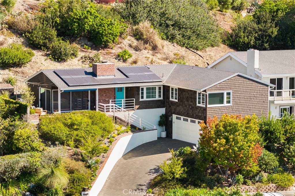 Experience coastal elegance within this completely reimagined single-level home in Lower Temple Hills. Wrapped in classic wood shingles, this home exudes timeless character while offering modern upgrades including a newer roof and fully owned solar. Here, sweeping views of the ocean, rolling hills, and breathtaking sunsets set the stage for everyday living.
Step inside to find European engineered hardwood floors and all-new dual-paned casement windows with tempered glass. The upgraded kitchen boasts Thermador appliances—including the dishwasher, induction cooktop, and oven—paired with self-closing cabinetry, a built-in Liebherr refrigerator, and a pantry with built-in drawers, creating the perfect space for both cooking and entertaining.
A gas brick fireplace warms the living room, where ocean views become the backdrop of daily life. The kitchen, breakfast nook, and primary suite also capture stunning coastal vistas. Outdoors, a wraparound brick patio with a built-in BBQ provides the ideal setting for gatherings with a view.
Both bathrooms have been remodeled with designer Daltile tile, walk-in showers, and Room & Board vanities topped with quartz counters. The primary bath is accented with Serena & Lily wallpaper for a refined touch. Motorized shades, a 2-car side-by-side garage with EV charging, solar battery, and a built-in storage shed add modern convenience. Recent upgrades include a newer Goodman A/C and furnace, top loading washer and dryer, and water heater (2022–2023), ensuring comfort year-round.
Enjoy the perfect location close to shops, restaurants, art galleries, and world-class surf at Thalia Street—plus all that vibrant Laguna Beach living has to offer. Every detail has been thoughtfully considered within the last five years, creating a turnkey retreat that blends cottage character with today’s most desired amenities.