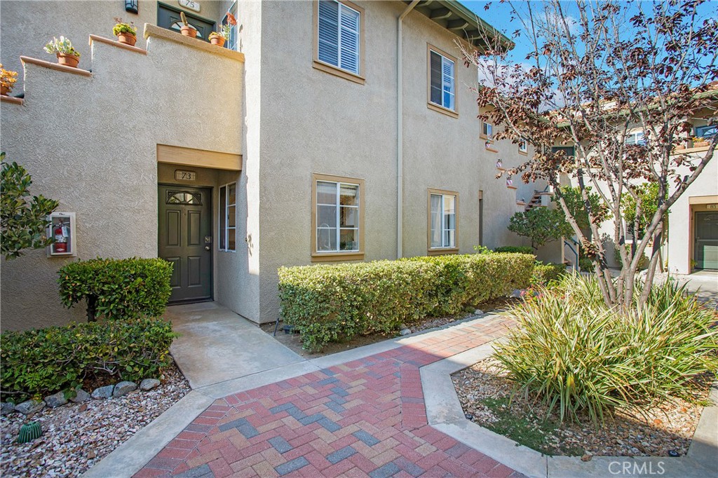 Charming single-level residence located in the scenic of Tijeras Creek Villas. A picturesque courtyard leads you to an inviting and upgraded open and light filled floor plan. The spacious living room features a stacked stone two-sided fireplace with gas logs and a French door that opens to a private, covered patio. The cheerful kitchen includes windows on two walls overlooking the private courtyard. The kitchen has been updated with white cabinetry, granite countertops, recessed lighting stainless appliances that include 5 burner gas range, microwave, dishwasher and refrigerator. The primary bedroom opens through tall sliding doors to the peaceful patio and also includes a mirrored closet with an organizer system. The remodeled bathroom features a white shaker style vanity, framed mirror, brushed fixtures and lighting plus additional cabinetry with glass doors providing additional storage. This home also offers a full-size front-loading washer and dryer (included), a hall closet, and additional storage spaces off the patio. You'll also appreciate the oversized one-car garage for even more storage with new roll up garage door, opener and walking access door. Community amenities include two pools (one with Tijeras Creek Golf Course views), a spa, sauna, and fitness center, along with full access to SAMLARC amenities such as pools, sports courts, parks, and the popular Lago Santa Margarita Beach Club with private events. Tucked in a private setting surrounded by views of trees and mountain views. with maintained landscaping and cul-de-sac location ensures a tranquil living experience. This home offers both comfort and convenience—just a short walk to the award-winning Arroyo Vista K-8 school in CA's safest city.