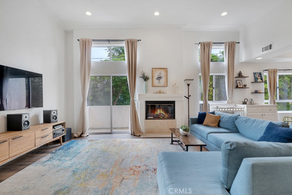 Beautiful end-unit townhouse in Sherman Oaks-adjacent Valley Glen! This highly desirable floor plan located in the Woodman Villas features 3 bedrooms, 2.5 bathrooms, and gorgeous natural light throughout. The main living room is ideal for entertaining, with a separate formal dining area and a wet bar. The charming kitchen offers plenty of counter space and storage, as well as a roomy breakfast nook. Upstairs, you'll find 2 well-appointed bedrooms with a shared full bathroom. The primary bedroom is a tranquil retreat with high ceilings, 2 walk-in closets, and a spacious en-suite bathroom. On the top level there is a bonus space that is perfect for a home gym, library, or art studio. This opens up to a rooftop patio with lovely views of the neighborhood. The bottom level features in-unit laundry and can also be used as a potential 4th bedroom, office space, or even a playroom. The attached 2-car garage features an EV charging station and more storage. The building exterior was recently painted and opens up to a picturesque Spanish-style courtyard. Enjoy one of the lowest HOA dues in the south Valley as well as easy access to Hollywood, DTLA, and the Westside.