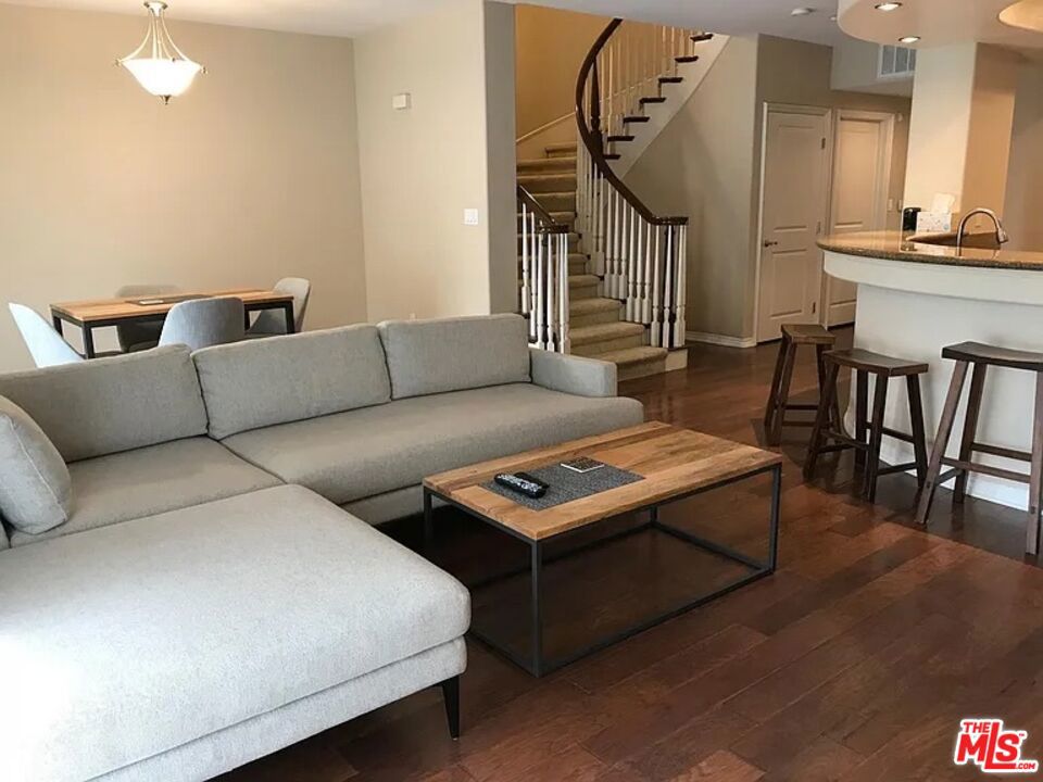 Stunning two-level condominium in the gated Serenade community of Playa Vista. This spacious 2-bedroom, 2.5-bath home boasts a grand curved staircase, soaring ceilings, and abundant natural light. The chef's kitchen features GE Monogram stainless appliances, granite countertops, and a breakfast bar open to the living area with a cozy gas fireplace. Relax in the luxurious primary suite with a private balcony, walk-in closet, and spa-inspired bath with soaking tub and separate shower. Enjoy seamless indoor/outdoor living with a private patio and floor-to-ceiling windows. Amenities include two attached garage spaces, secure elevator access, and exclusive use of the clubhouse, pool, spa, fitness center, and playground. Conveniently located near parks, shops, dining, and top-rated schools. Don't miss this opportunity to live in one of Playa Vista's premier communities!